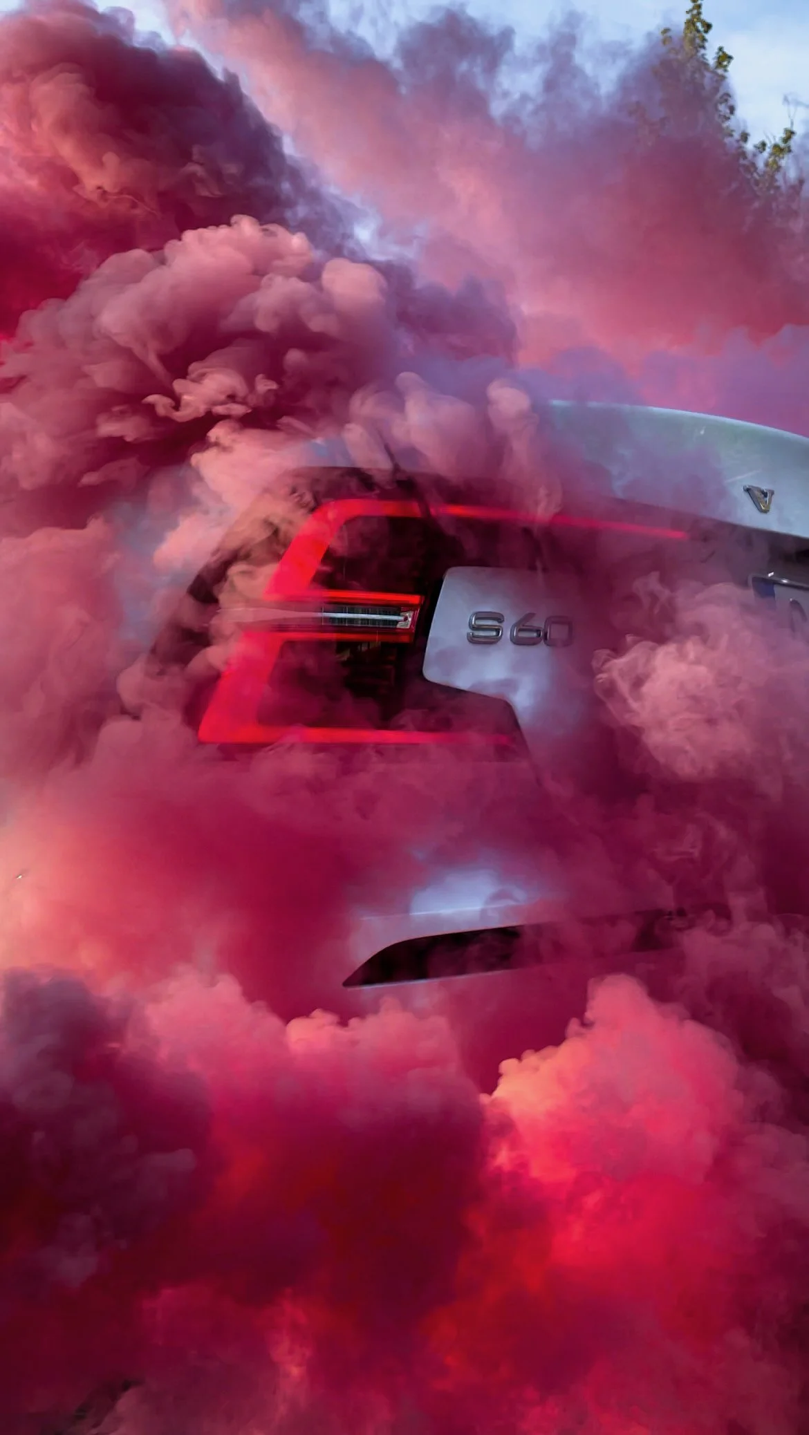 Black Volvo S60 rear light photographed in a cloud of pink smoke in Helsinki by Annika TheVolvoGirl Miftakhova 
