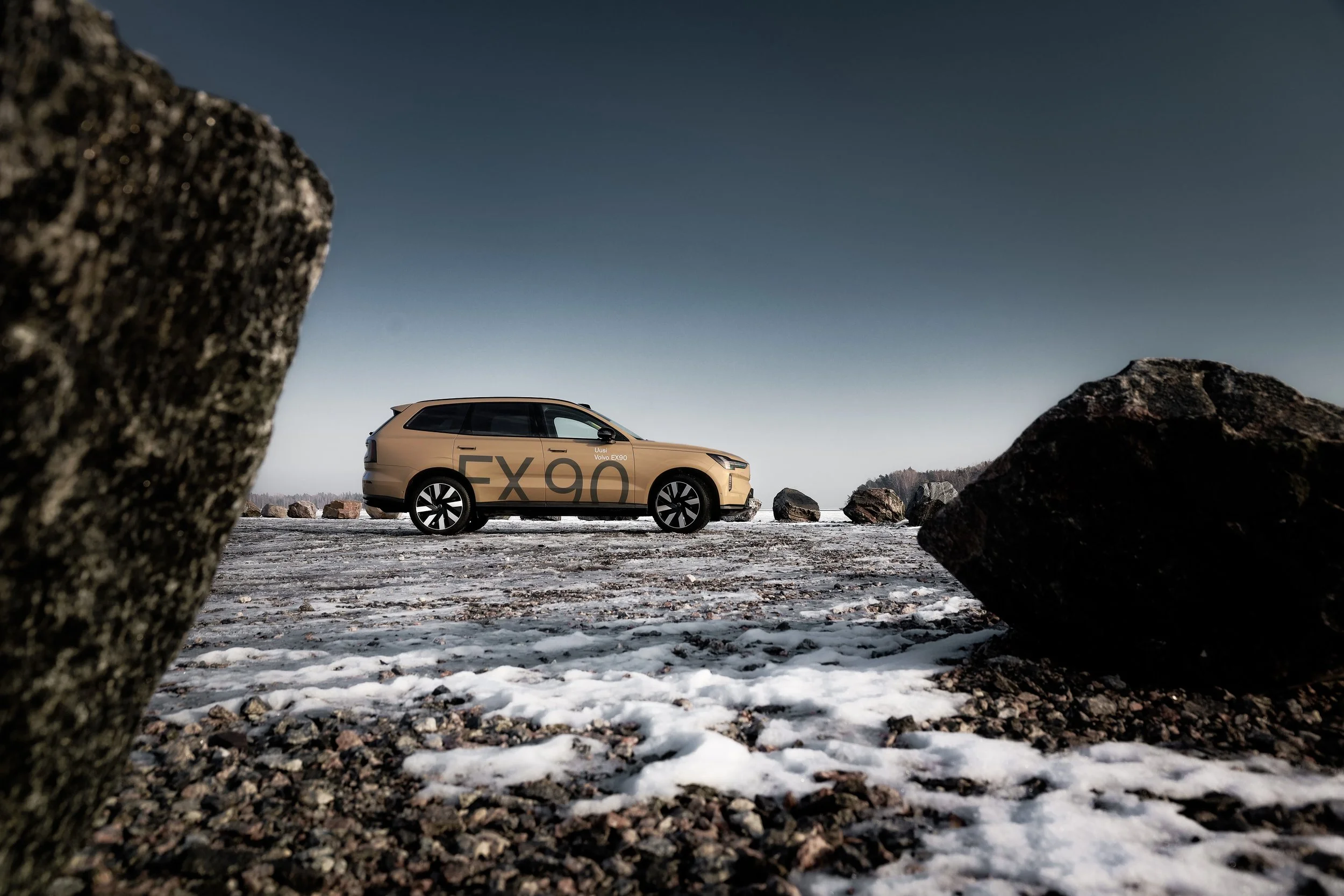 Side profile of beige Volvo EX90 photographed in open harbour area in Helsinki, Finland by Annika TheVolvoGirl Miftakhova