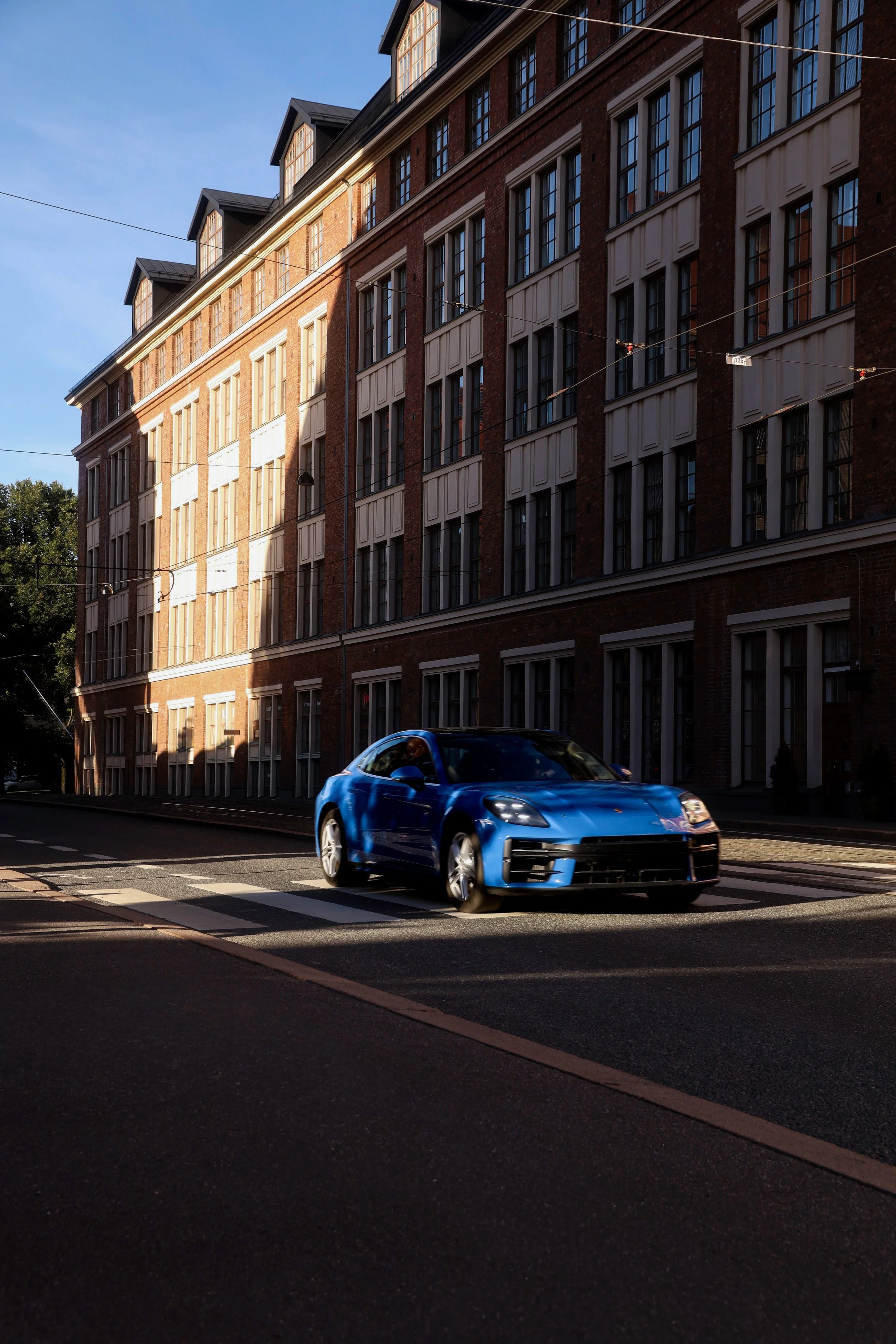 Special light and shadow car photo of a blue Porsche Panamera bursting photographed by Annika TheVolvoGirl Miftakhova in Helsinki, Finland