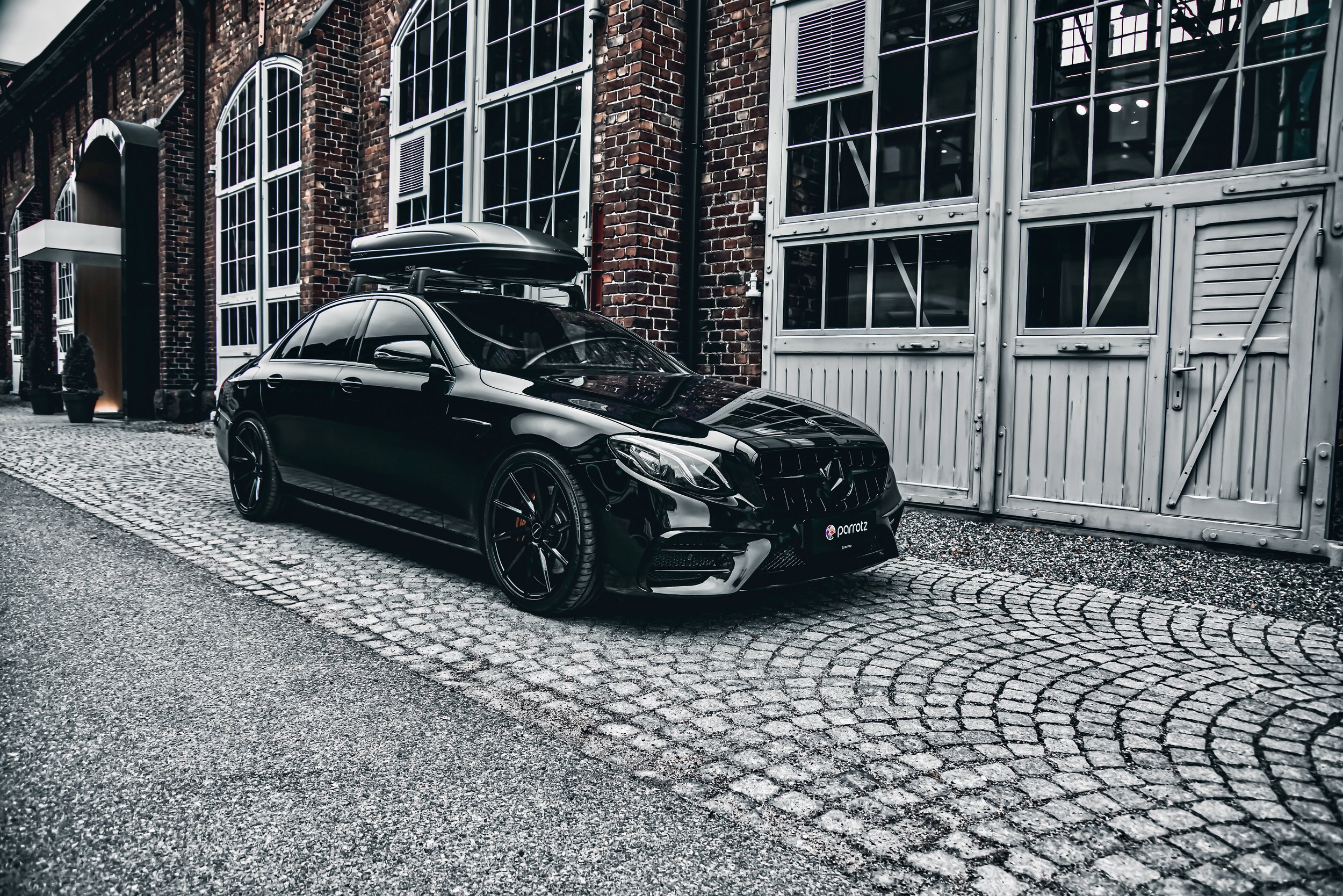 Black Mercedes-Benz E-class car photographed by Annika TheVolvoGirl Miftakhova for Parrotz Suomi in Helsinki, Finland