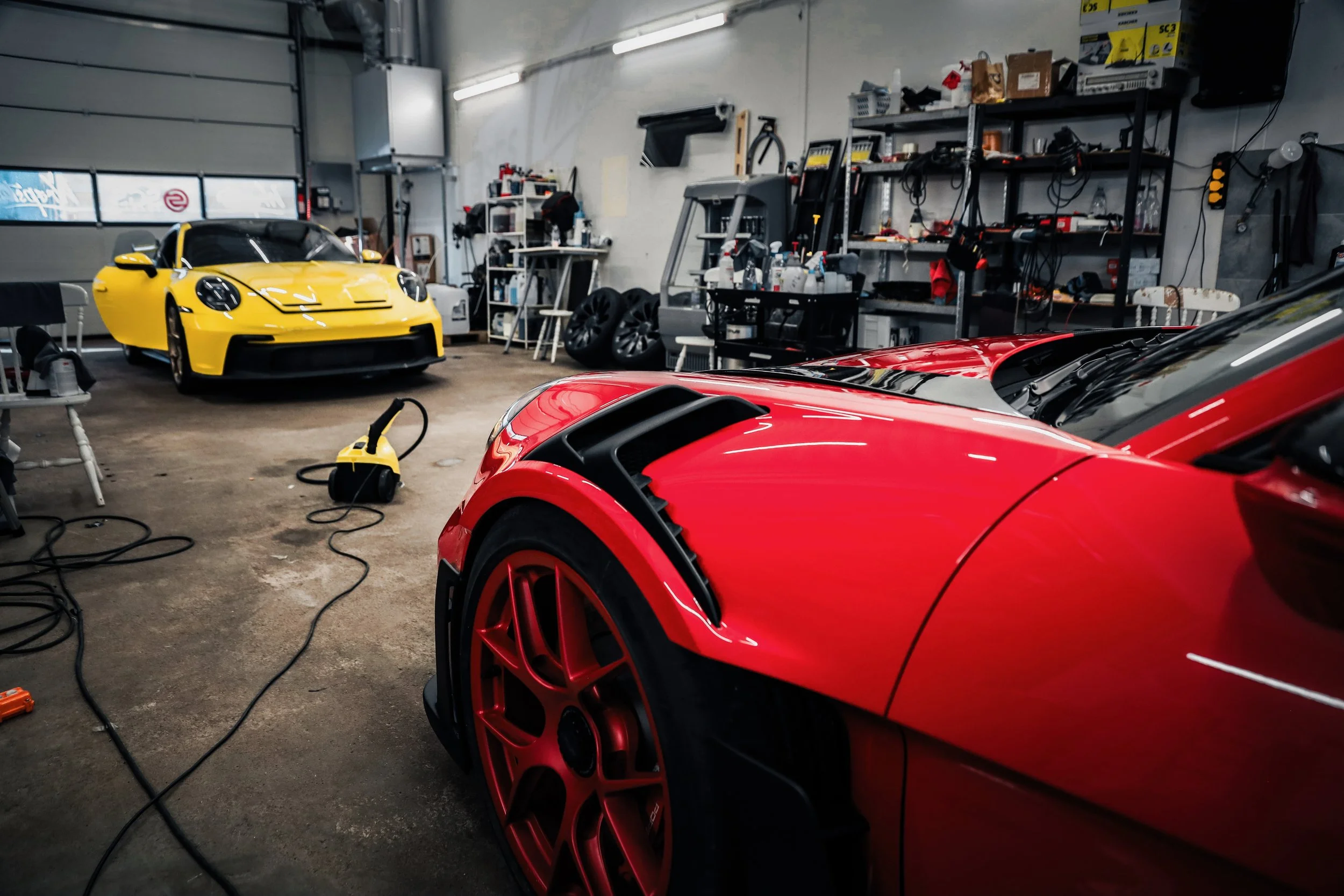 Yellow Porsche GT3 and Red Porsche GT3 RS prepared for Paint Protection Film at Wrapster Sweden in Örebro, Sweden, photographed by Annika TheVolvoGirl Miftakhova.