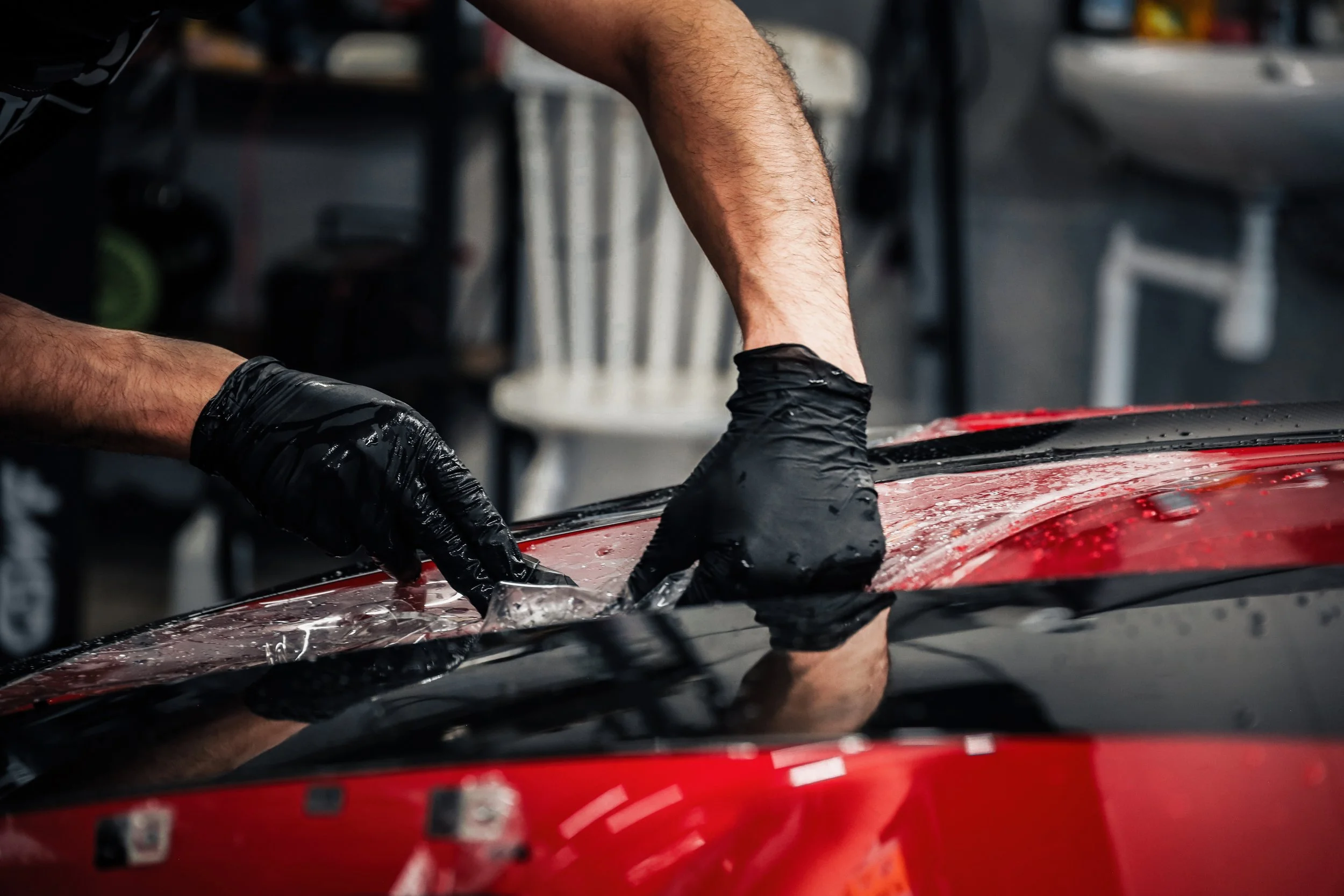 Wrapster workers install Paint Protection Film on the Red Porsche GT3 RS in Örebro, Sweden, photographed by Annika TheVolvoGirl Miftakhova.
