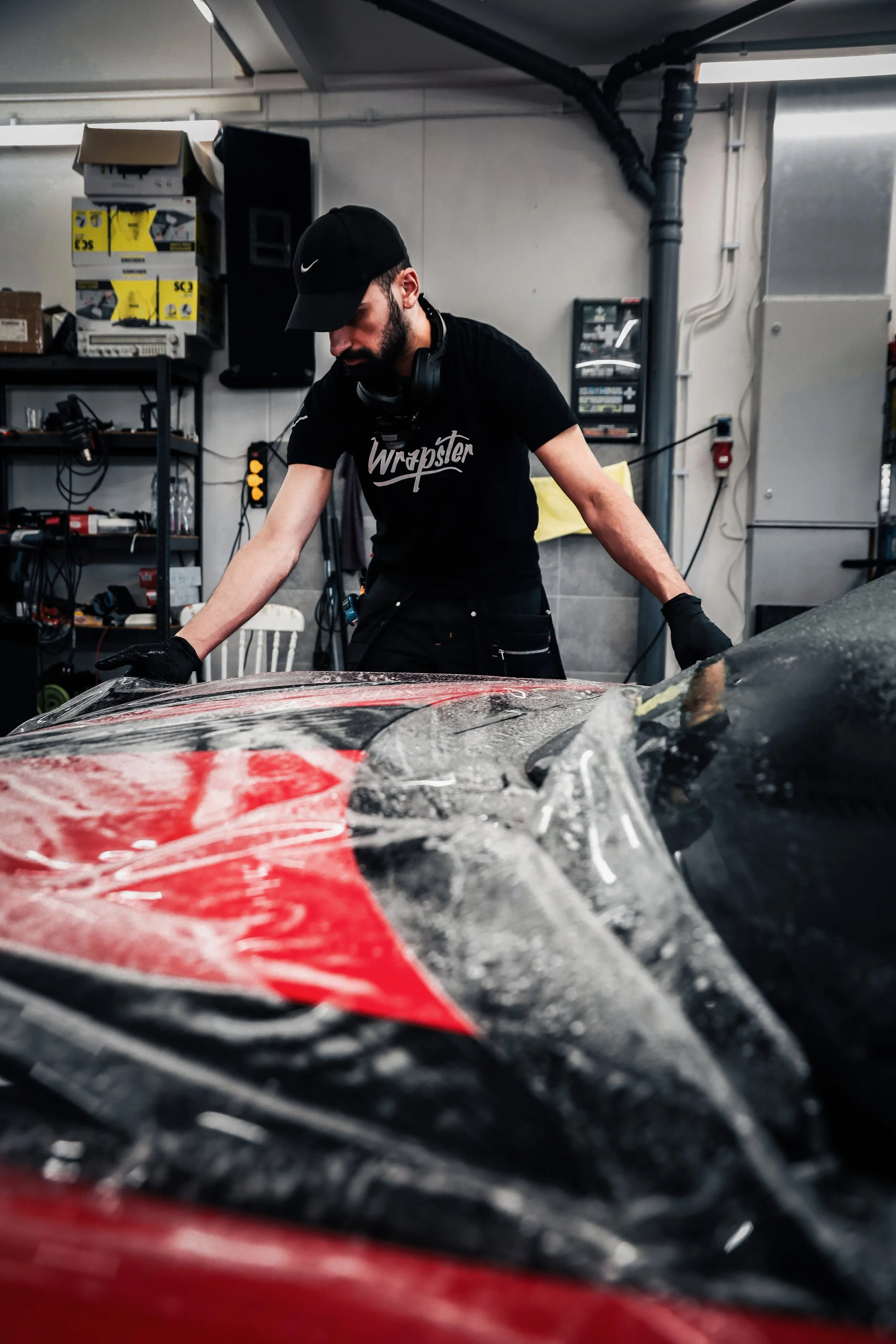 Wrapster workers stretch and place Paint Protection Film to the Red Porsche GT3 RS in Örebro, Sweden, photographed by Annika TheVolvoGirl Miftakhova.