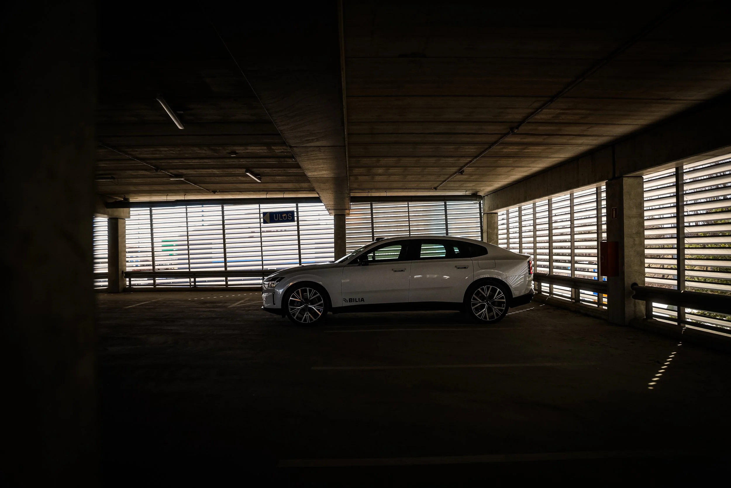 Side profile of White Volvo ES90 photographed in dimmed parking lot in Helsinki, Finland by Annika TheVolvoGirl Miftakhova