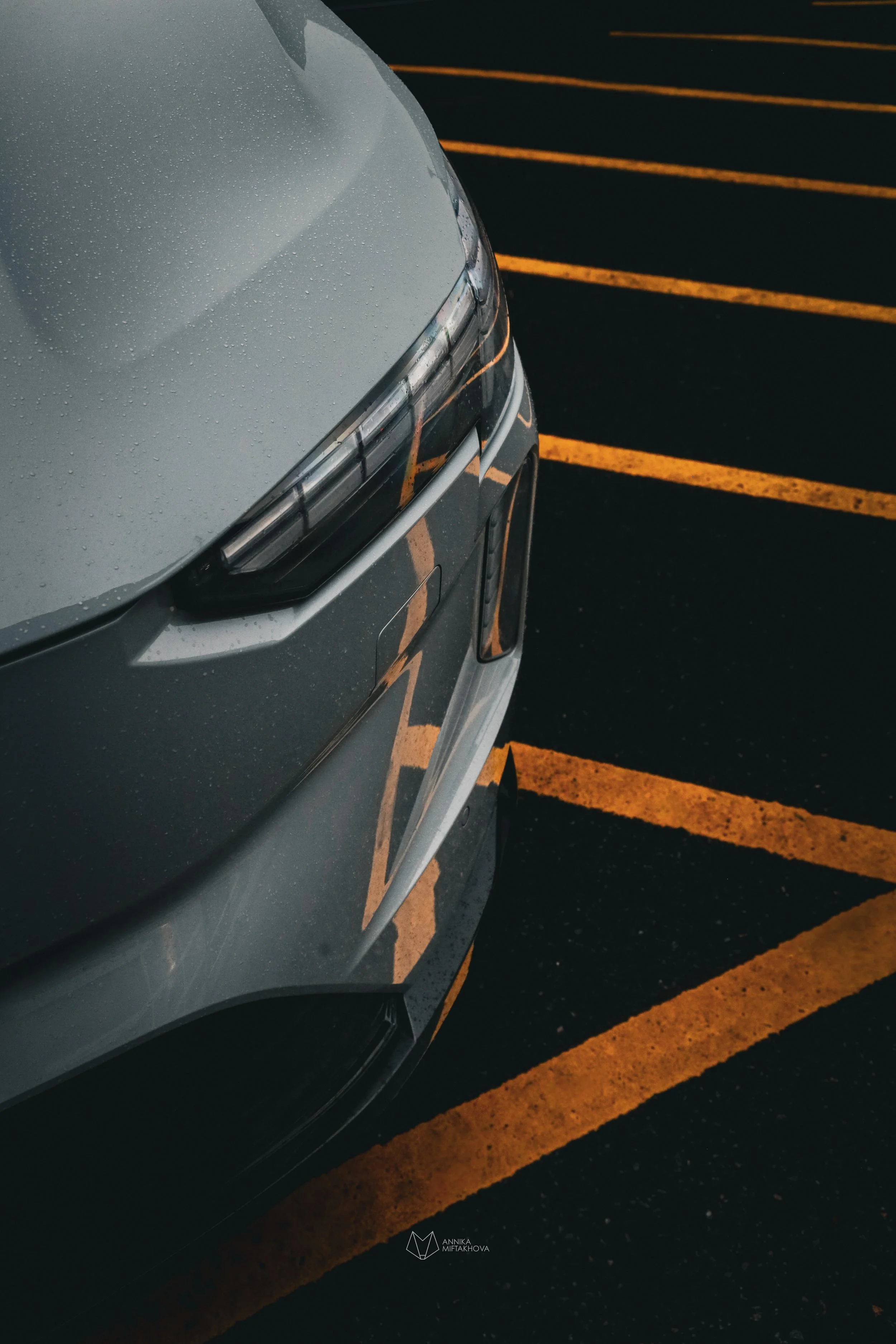 Grey Volvo EX90 photographed in rainy bright yellow parking lot in Helsinki by Annika TheVolvoGirl Miftakhova 