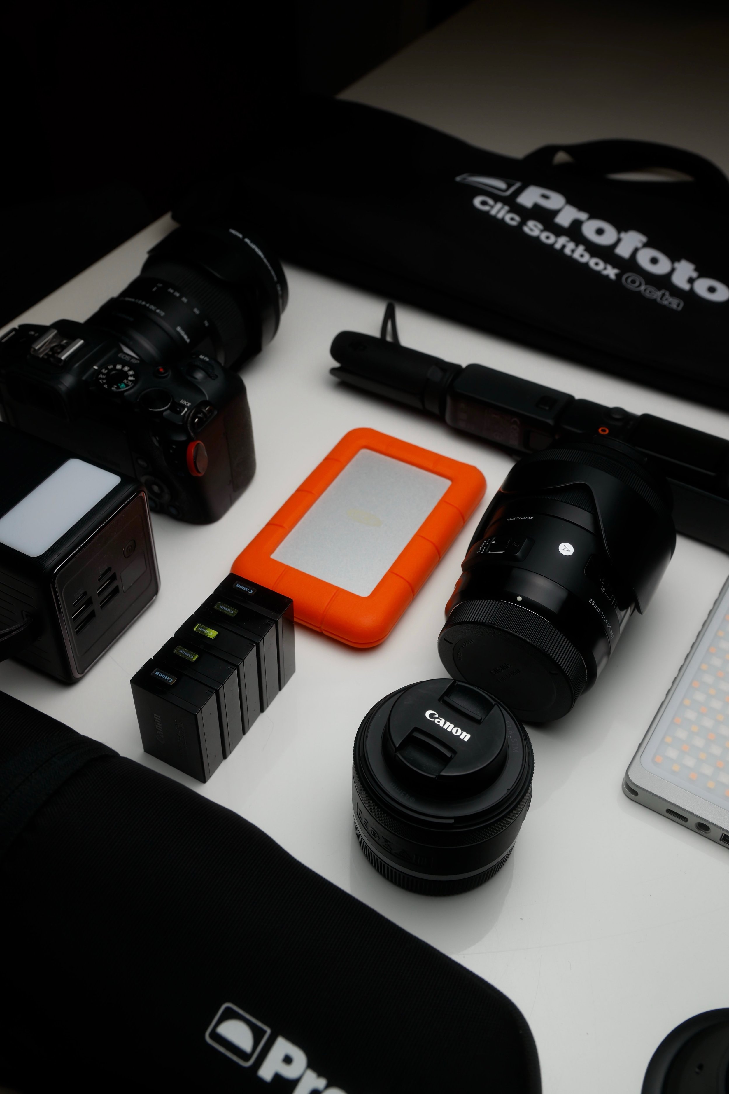 Photography gear laid out on the table to cover everything from photography to videography services by Annika Miftakhova