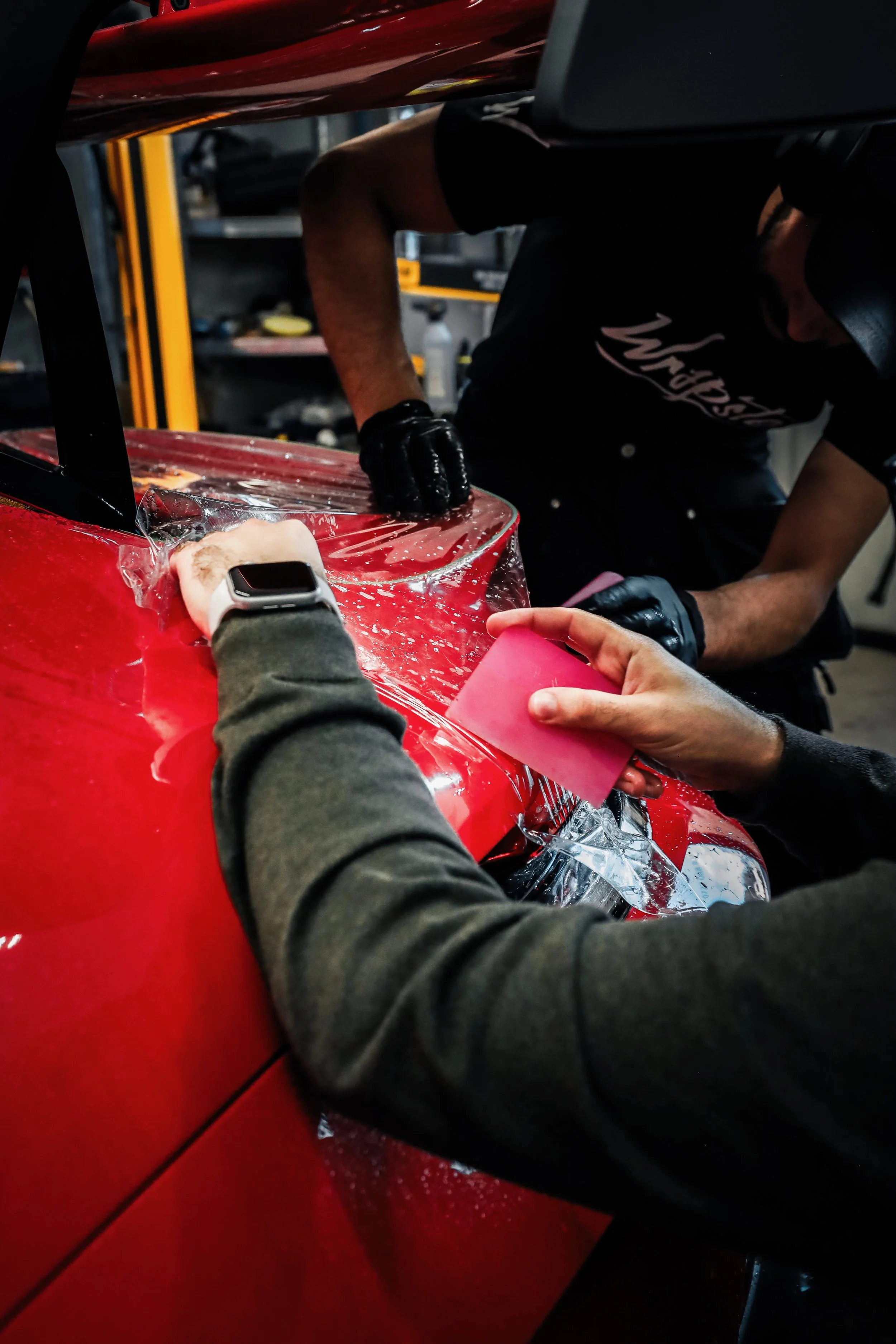 Wrapster workers install Paint Protection Film on the tail of Red Porsche GT3 RS in Örebro, Sweden, photographed by Annika TheVolvoGirl Miftakhova.