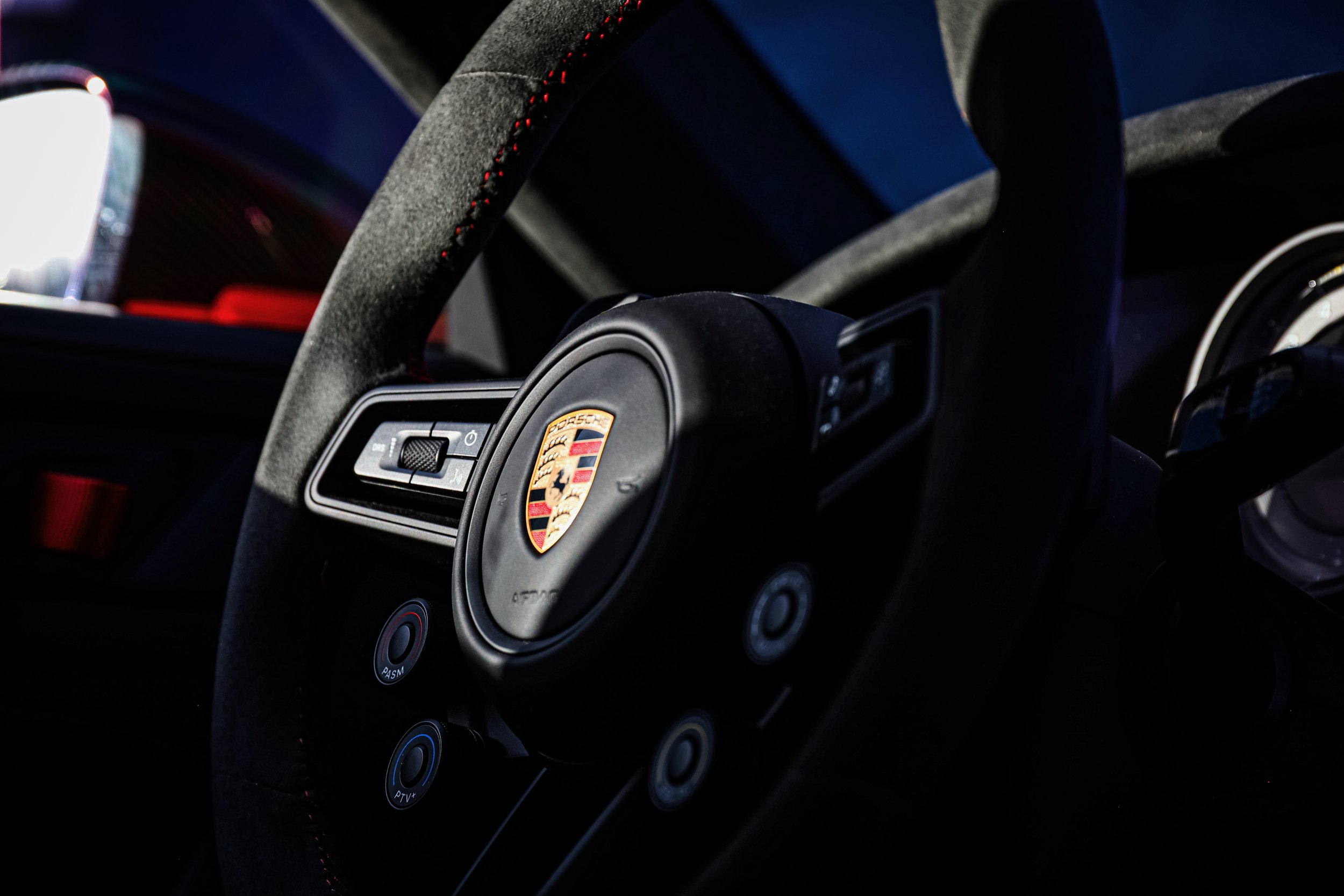 Steering wheel of the Red Porsche GT3 RS at Wrapster in Örebro, Sweden, photographed by Annika TheVolvoGirl Miftakhova.
