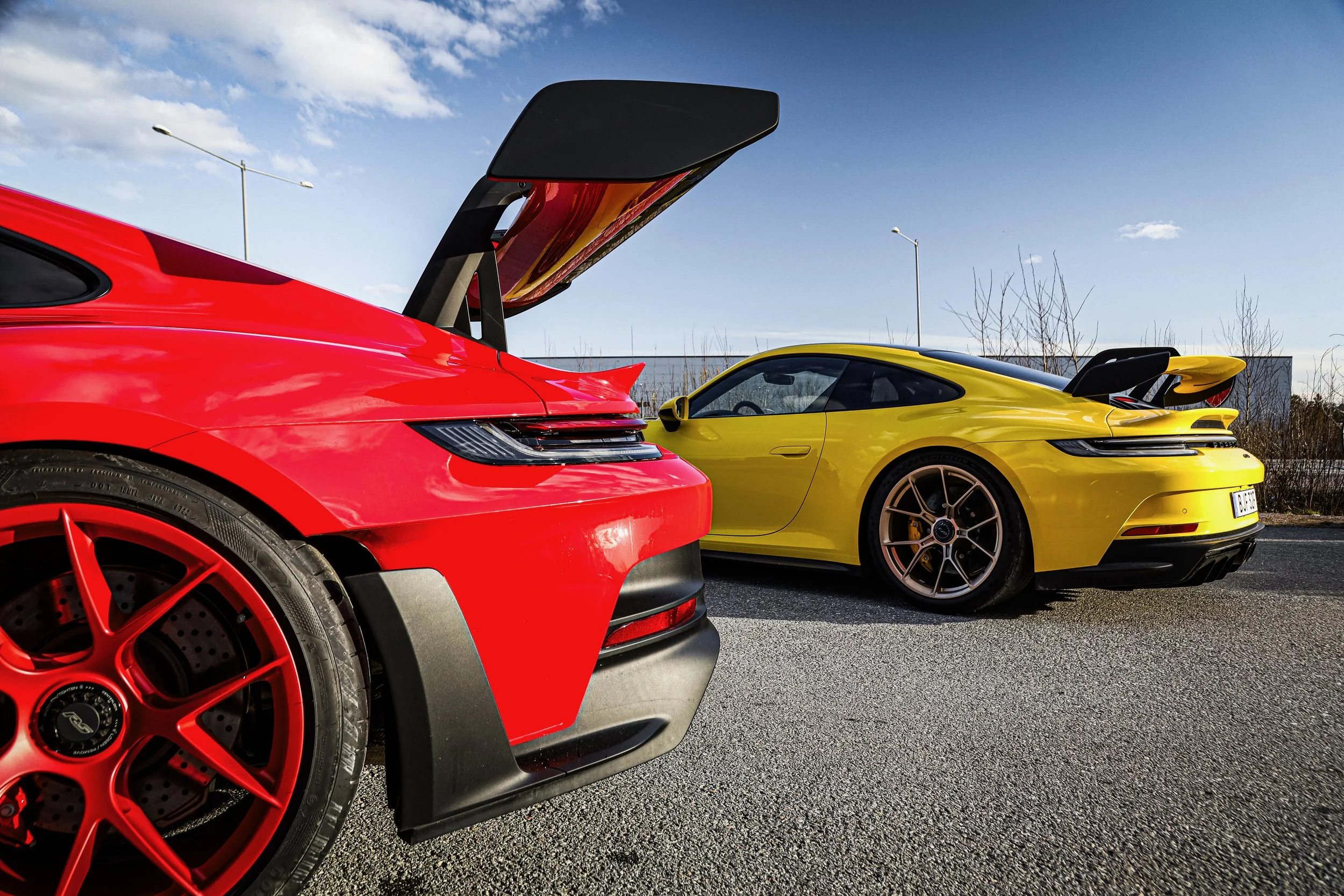 Tails of the Yellow Porsche GT3 and Red Porsche GT3 RS at Wrapster in Örebro, Sweden, photographed by Annika TheVolvoGirl Miftakhova.