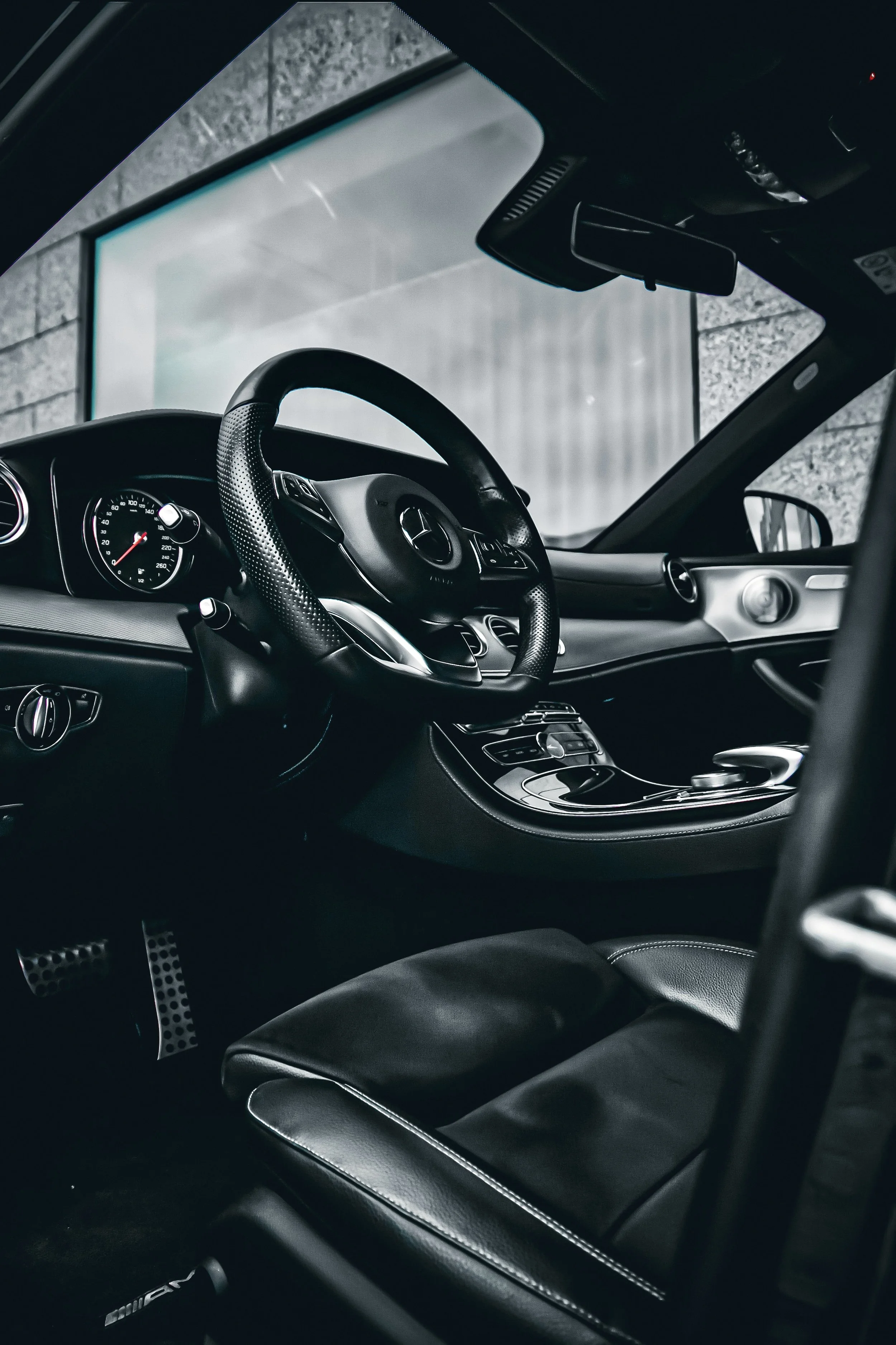 Driver interior of Black Mercedes-Benz E-class car photographed by Annika TheVolvoGirl Miftakhova for Parrotz Suomi in Helsinki, Finland