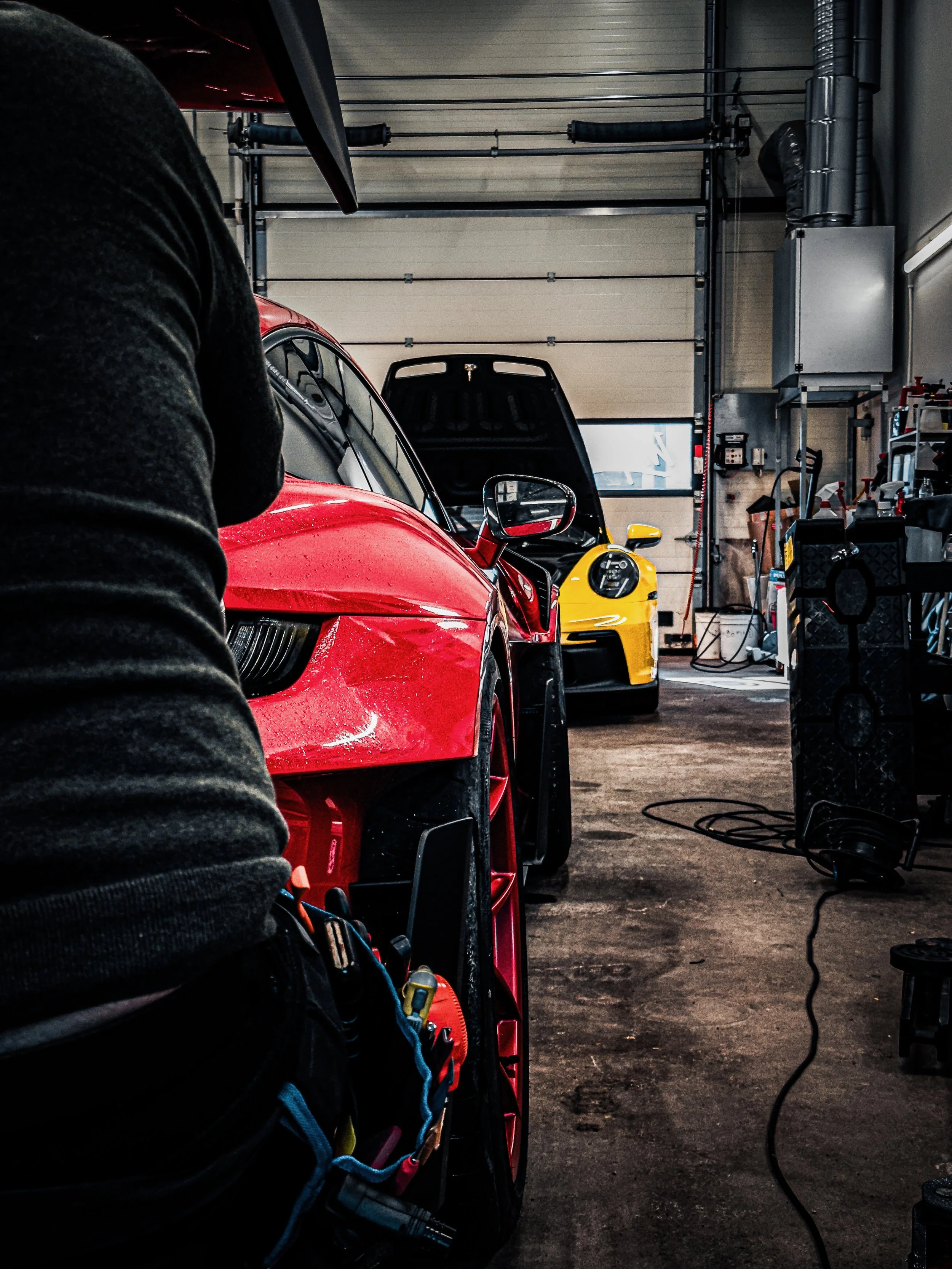 Yellow Porsche GT3 and Red Porsche GT3 RS prepared for Paint Protection Film at Wrapster Sweden in Örebro, Sweden, photographed by Annika TheVolvoGirl Miftakhova.