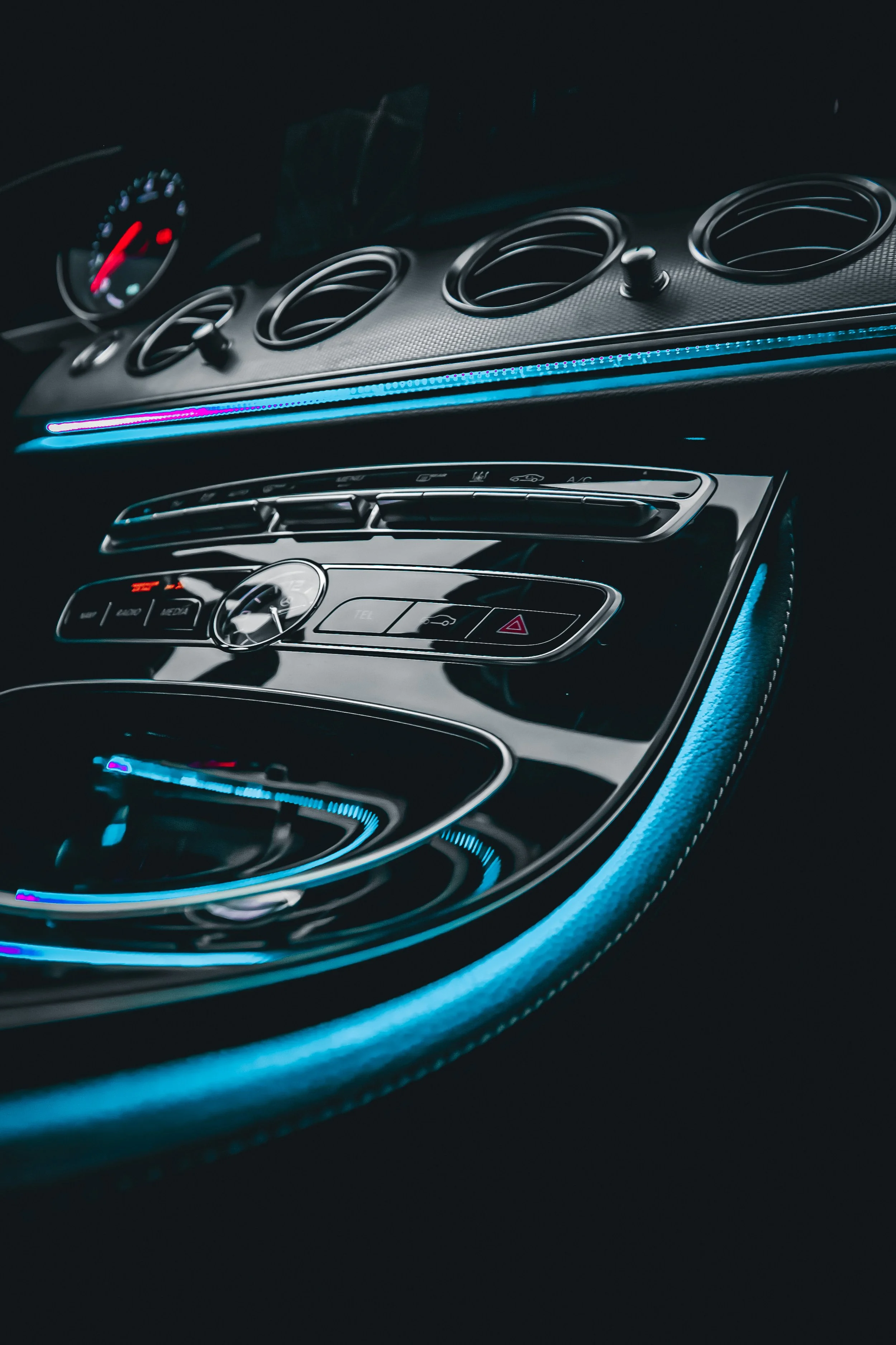 Lit up central console of Black Mercedes-Benz E-class car photographed by Annika TheVolvoGirl Miftakhova for Parrotz Suomi in Helsinki, Finland