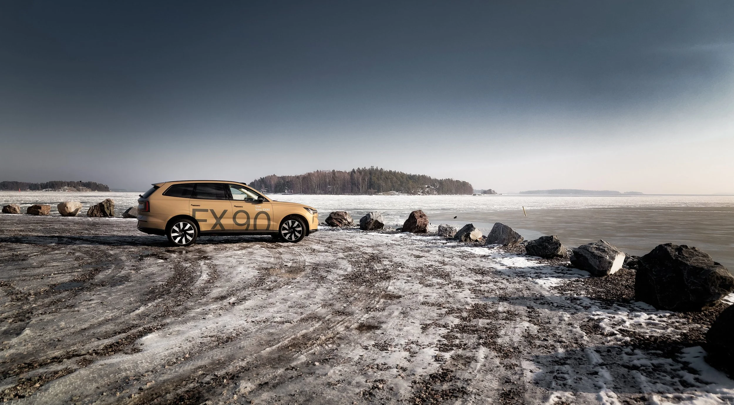 Side profile of beige Volvo EX90 photographed in open harbour area in Helsinki, Finland by Annika TheVolvoGirl Miftakhova