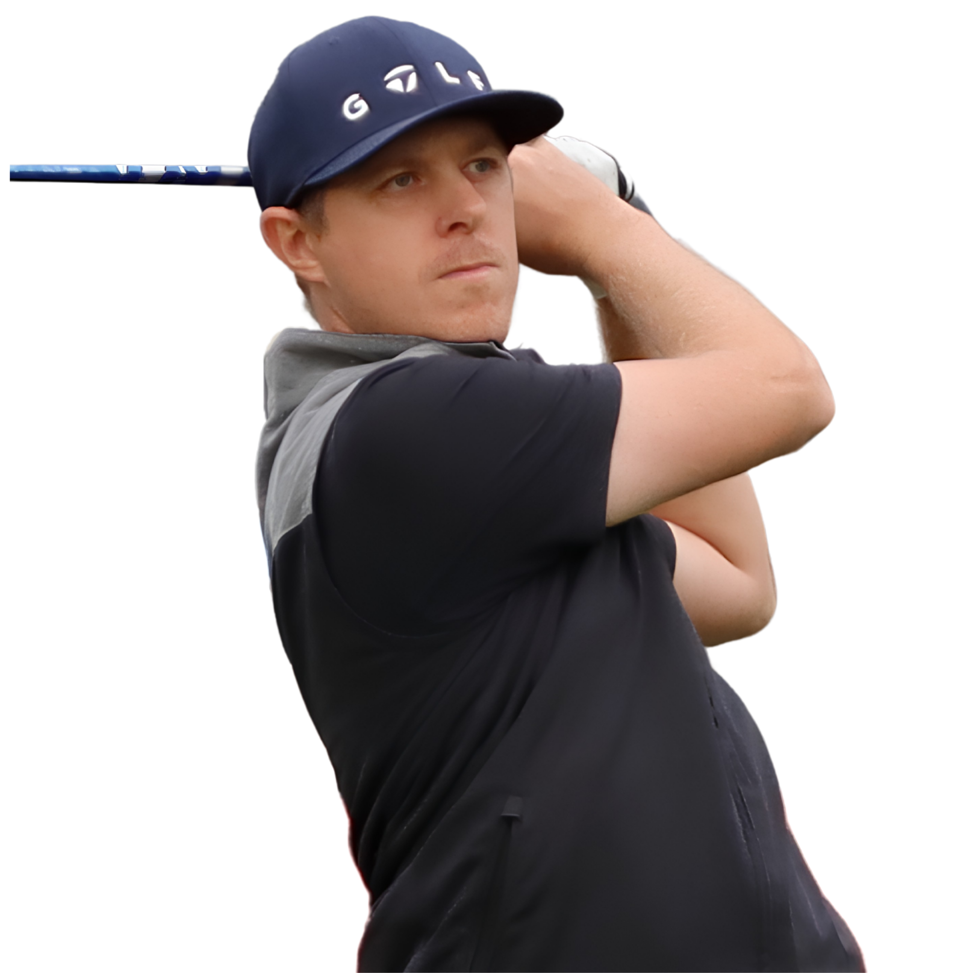 A young man with fair skin wearing a dark baseball cap and a black shirt, holding a blue and white golf club, appears to be in a moment of concentration, likely preparing to take a shot on a golf course.