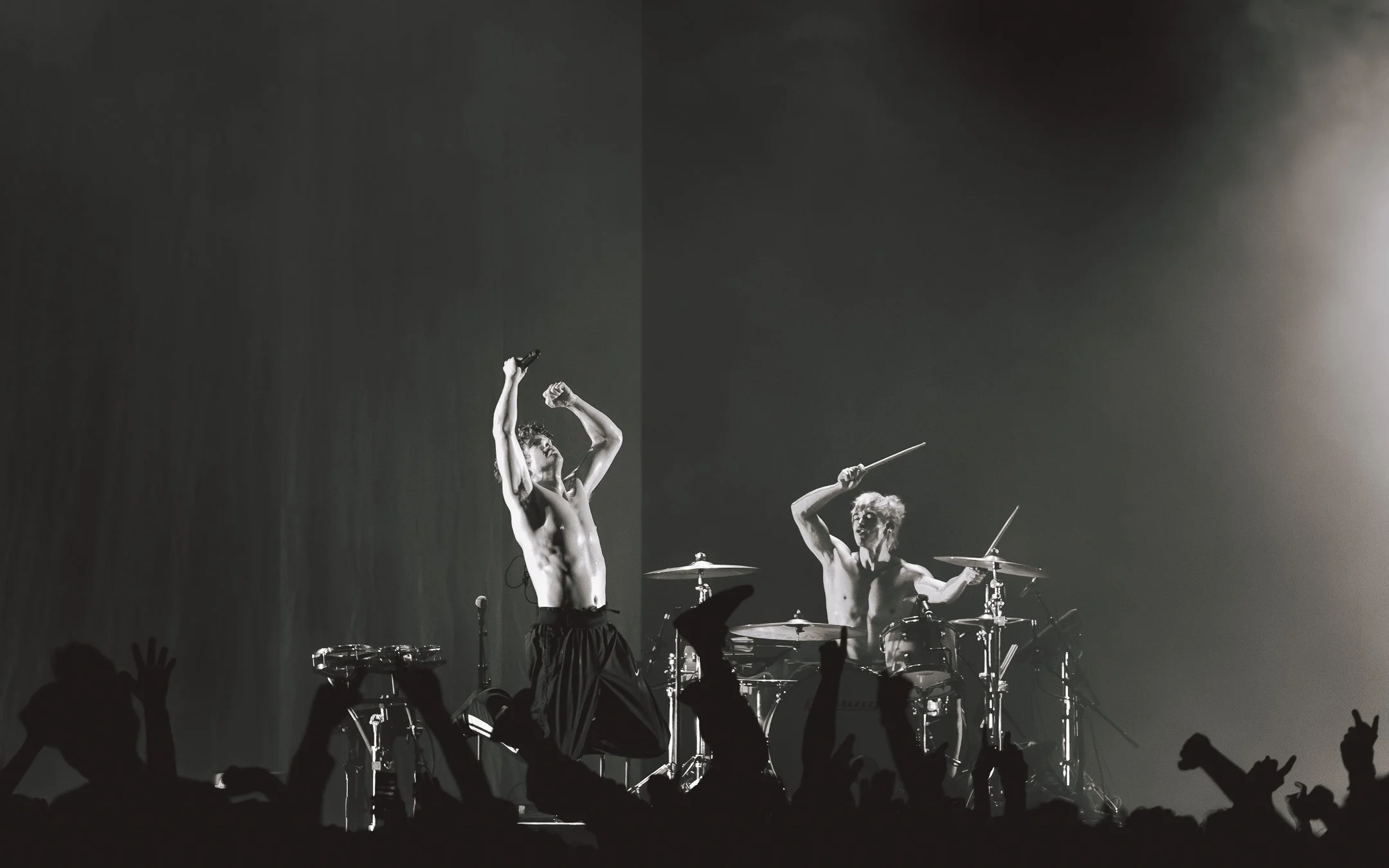 The lead singer of the punk band Turnstile, Brendan Yates jumping high with Daniel Fang, the drummer while performing live in europe, milan, italy photo taken by Levente Barabás aka fractionsofmyPOV