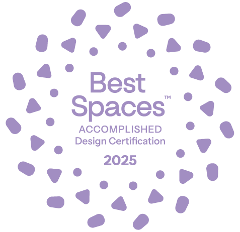 Best Spaces Design Certification Accomplished-level 2025 mark, featuring a light-purple radial design consisting of three concentric circles made of small geometric shapes.