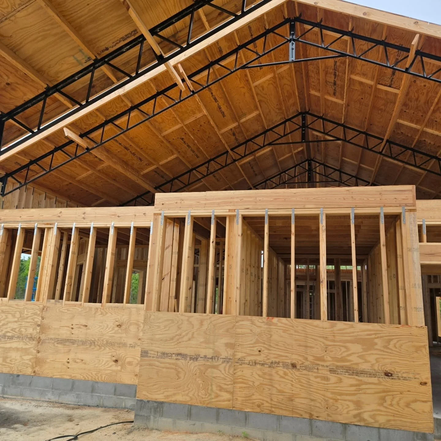 Wooden framing and roofing structure of a building under construction.