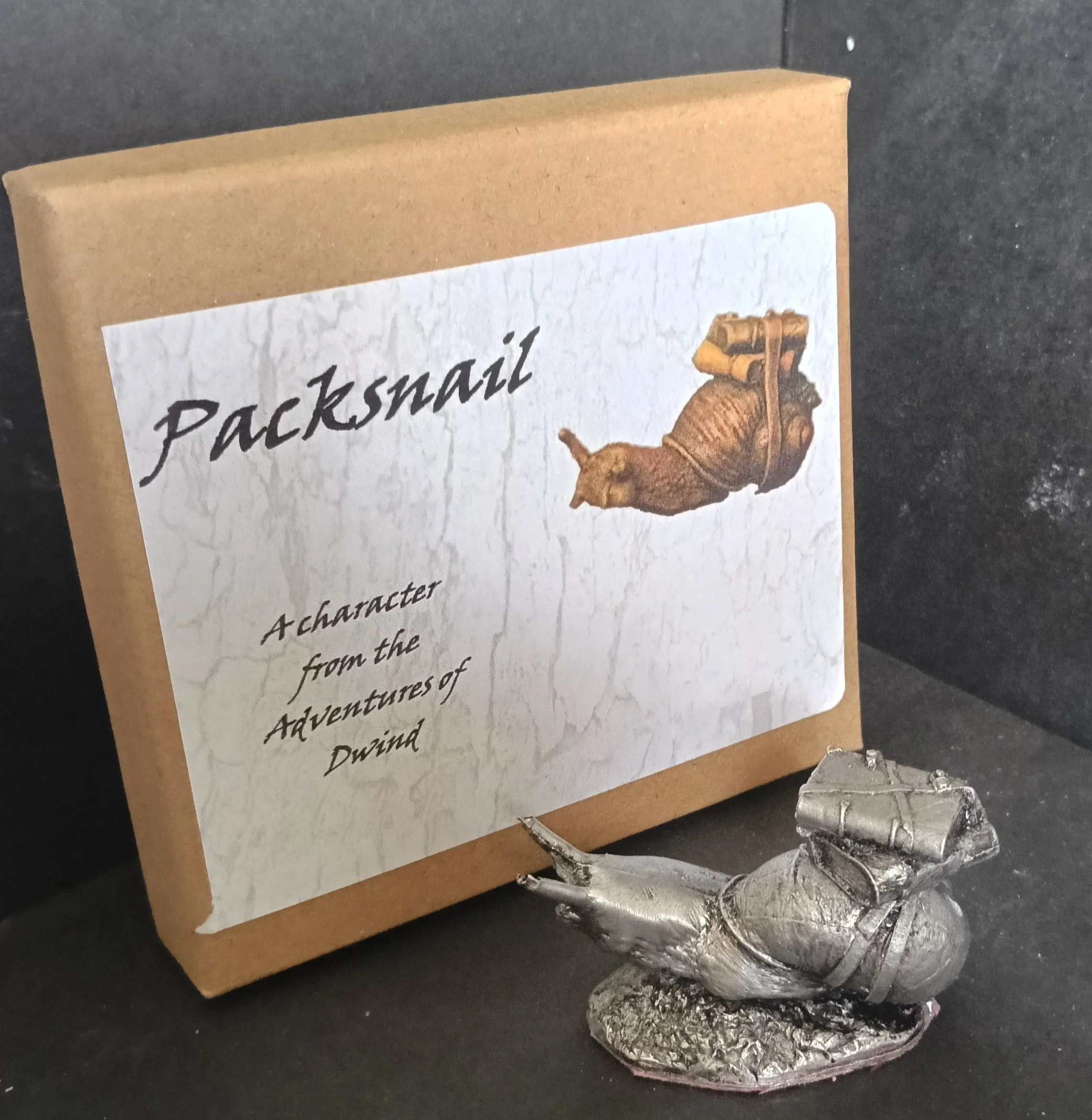 A collectible life size white metal figurine of  a packsnail used to transport equipment and the Insights of Hawkbit the Wise in the 'Adventures of Dwind', available as a kit or as an antiqued gift.