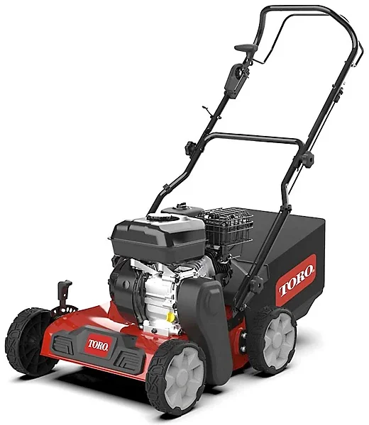 A Toro brand walk-behind lawn aerator with a gasoline engine, black handles, and red and black body.