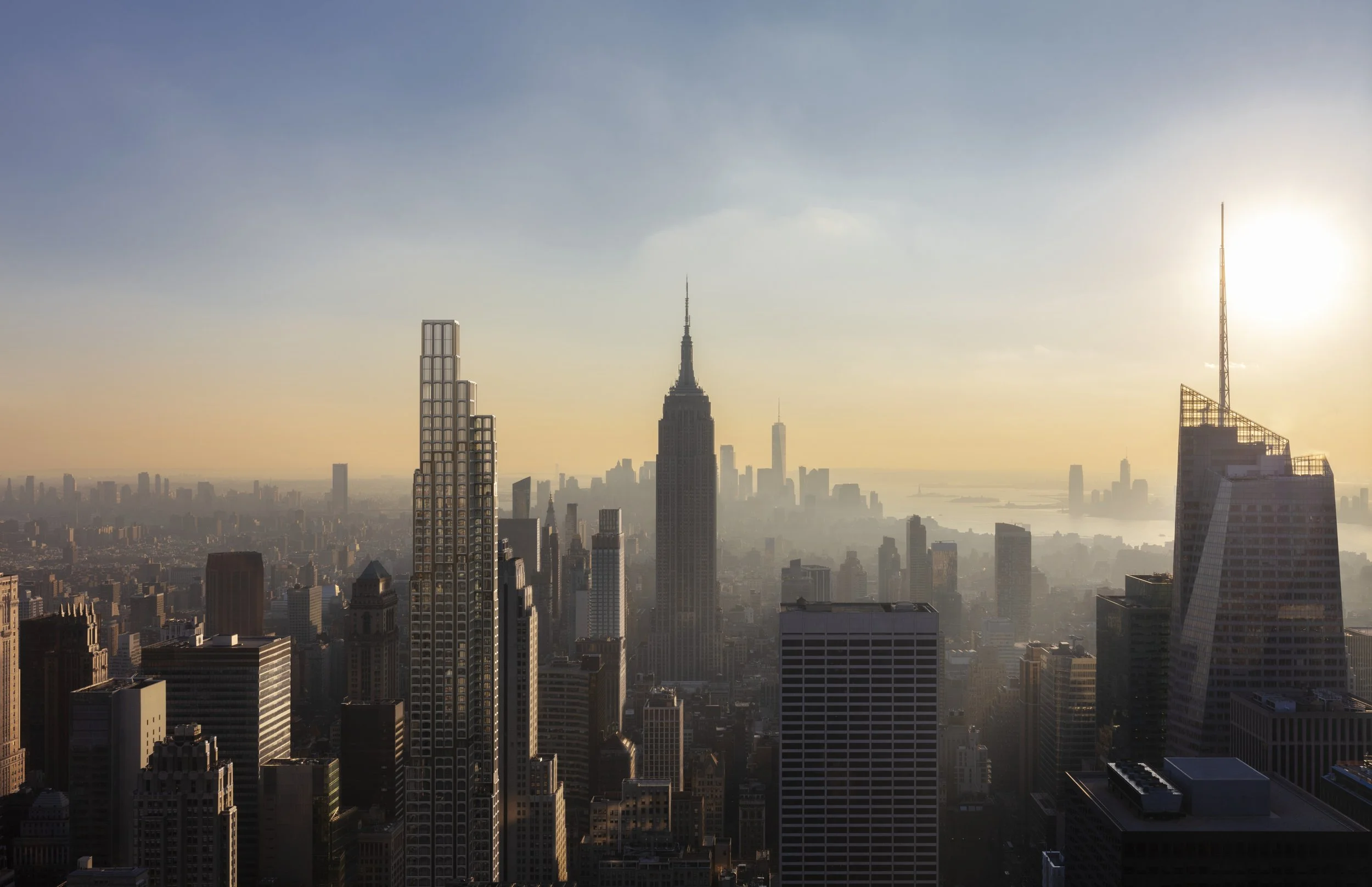 A city skyline during sunset with tall skyscrapers, including the Empire State Building, in New York City.