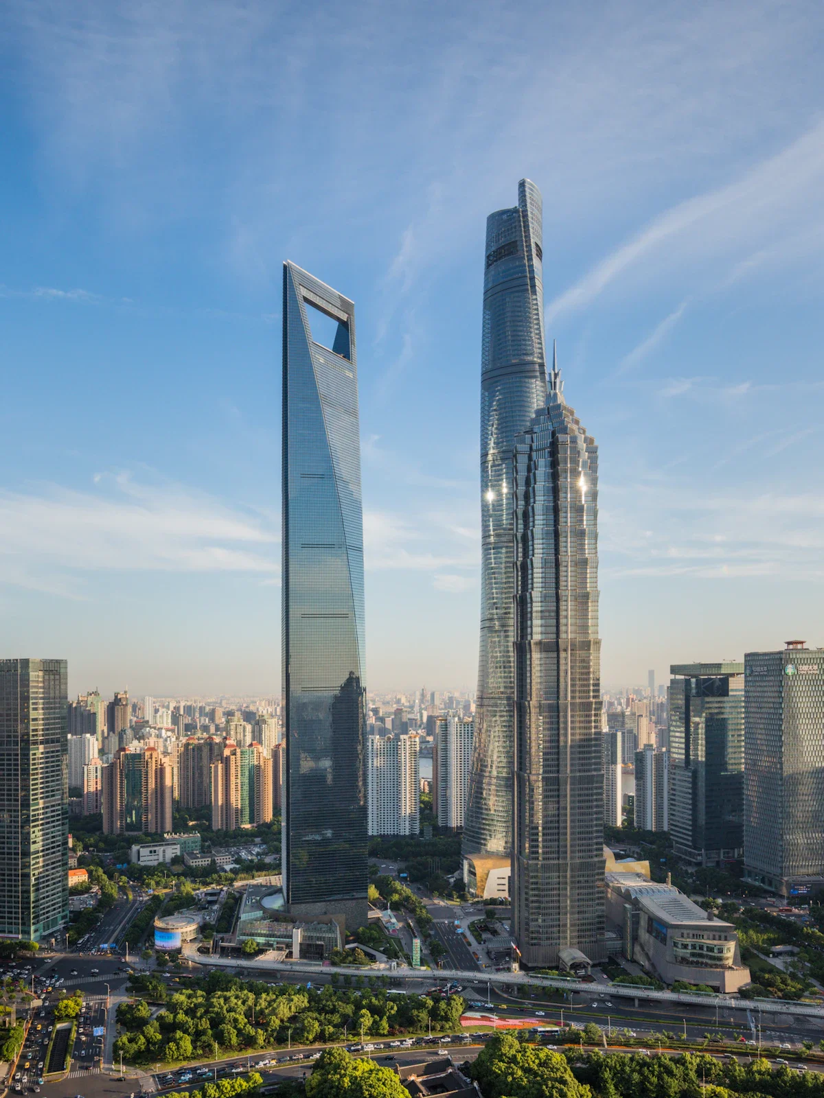 Skyscrapers in a city skyline, with modern glass buildings and a clear blue sky.