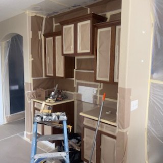 Kitchen cabinets being installed in a home renovation project.