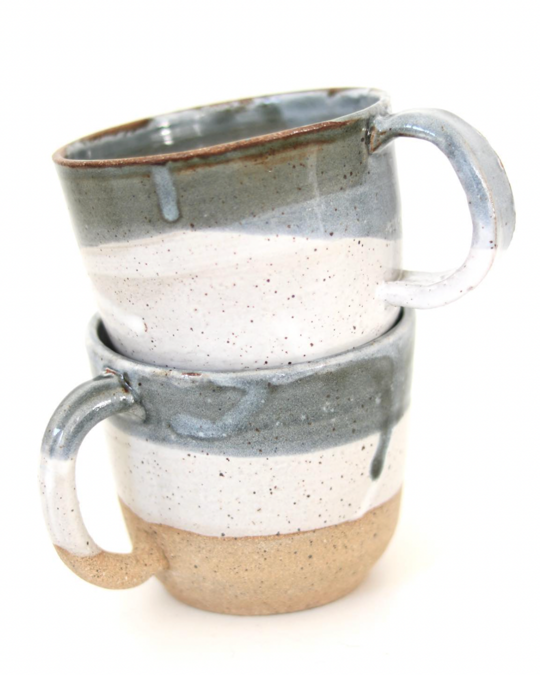 Two stacked ceramic coffee mugs with a speckled gray and beige glaze, isolated on a white background.