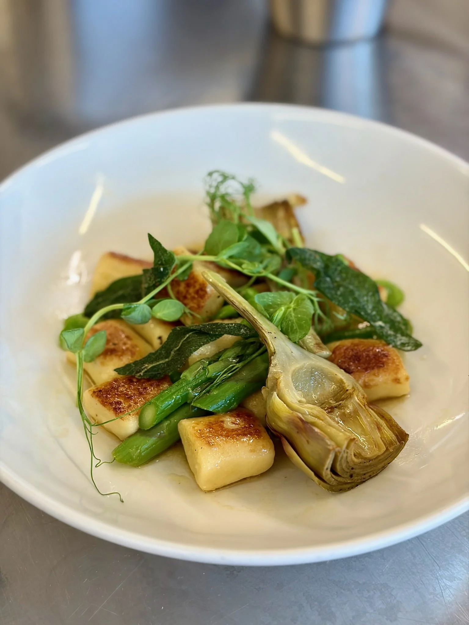 Potato gnocchi with spring vegetables, braised violet artichokes and sage.jpeg