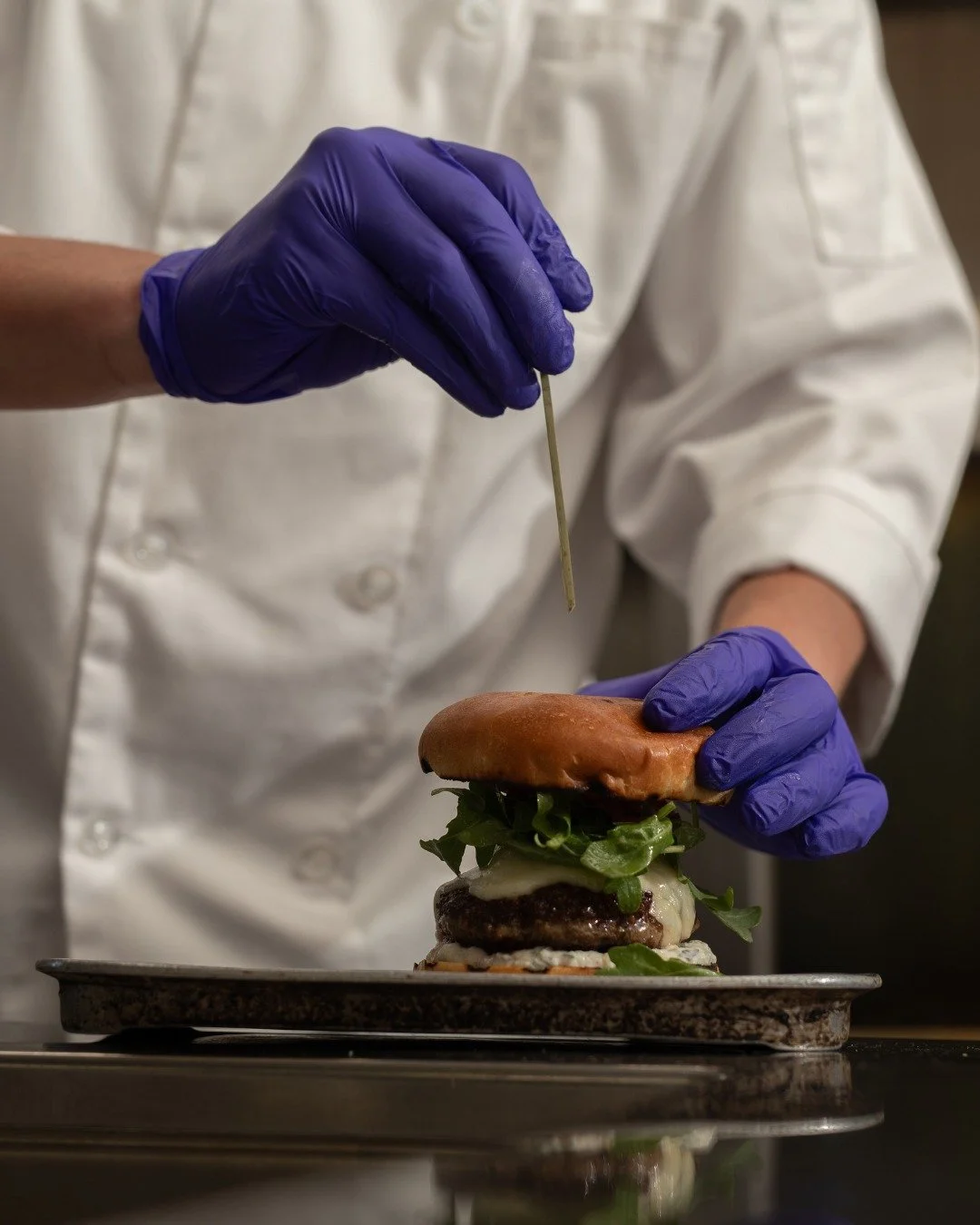 Let us introduce you to The '88 Burger. 

It's mouthwatering and juicy, with a spiced lamb patty, manchego cheese, raita, pickled red onion, and arugula, served on a toasted brioche bun with a side of fries. One bite of this and you'll be planning yo