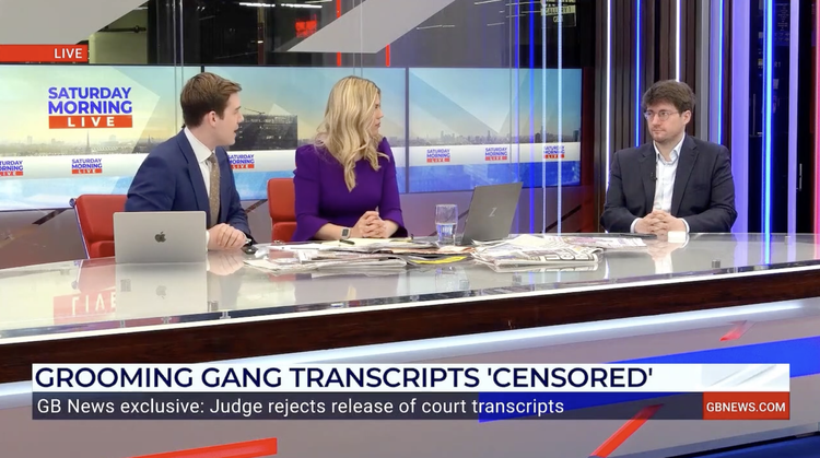 News broadcast with three people sitting at a desk, two men and one woman, discussing. Background displays 'Saturday Morning Live'. Lower third reports 'Grooming Gang Transcripts 'Censored'' with a subheading about a judge rejecting court transcripts release.