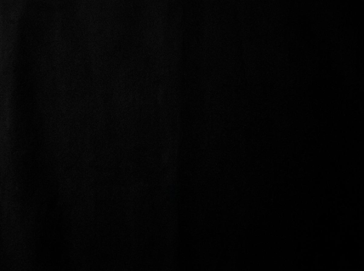 Black image with faint, barely visible texture or pattern.