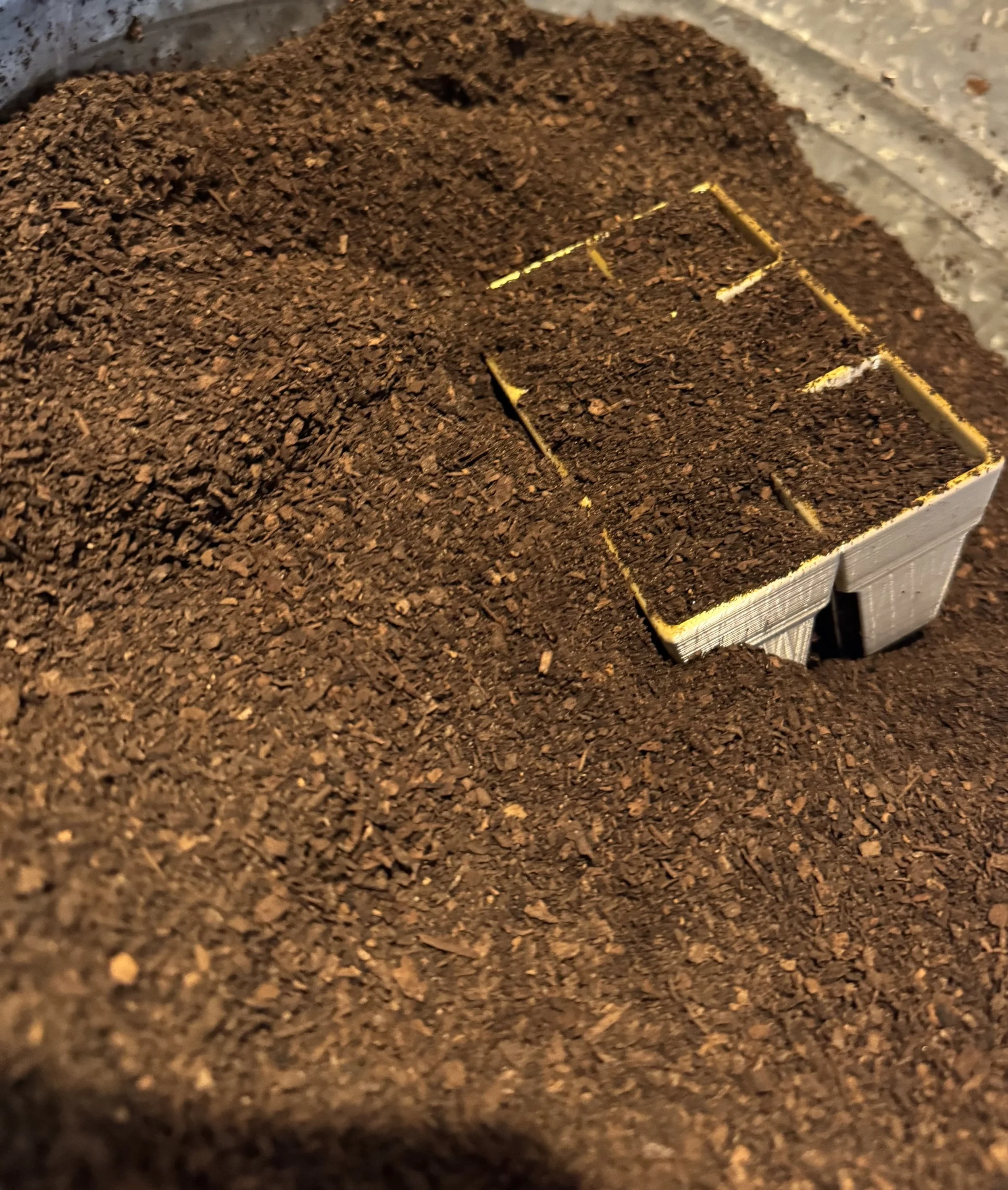 Close-up of a metallic container filled with Quick Pony Farms Seed Start Mix.