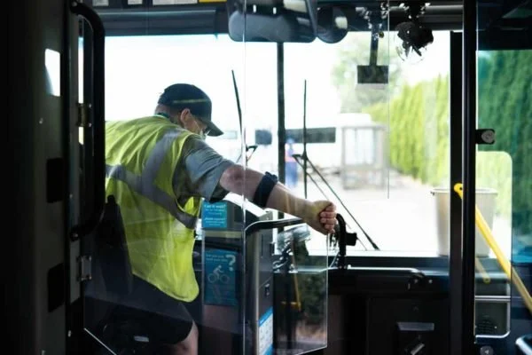 TransitGuard DriverBarrier protecting a transit bus operator while preserving visibility and access.