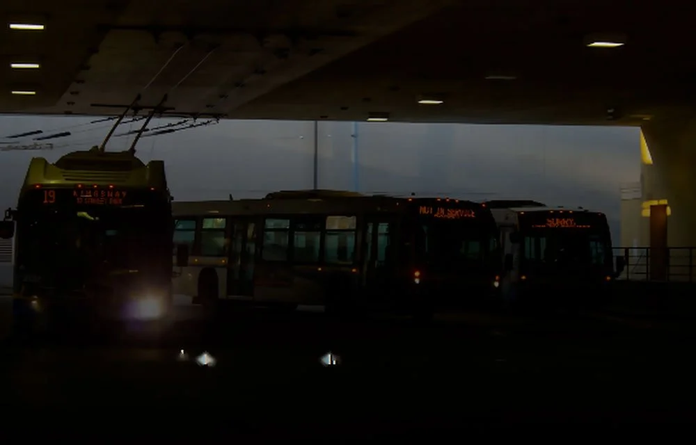 Transit buses parked inside a maintenance facility equipped for integrated fire detection and suppression protection.