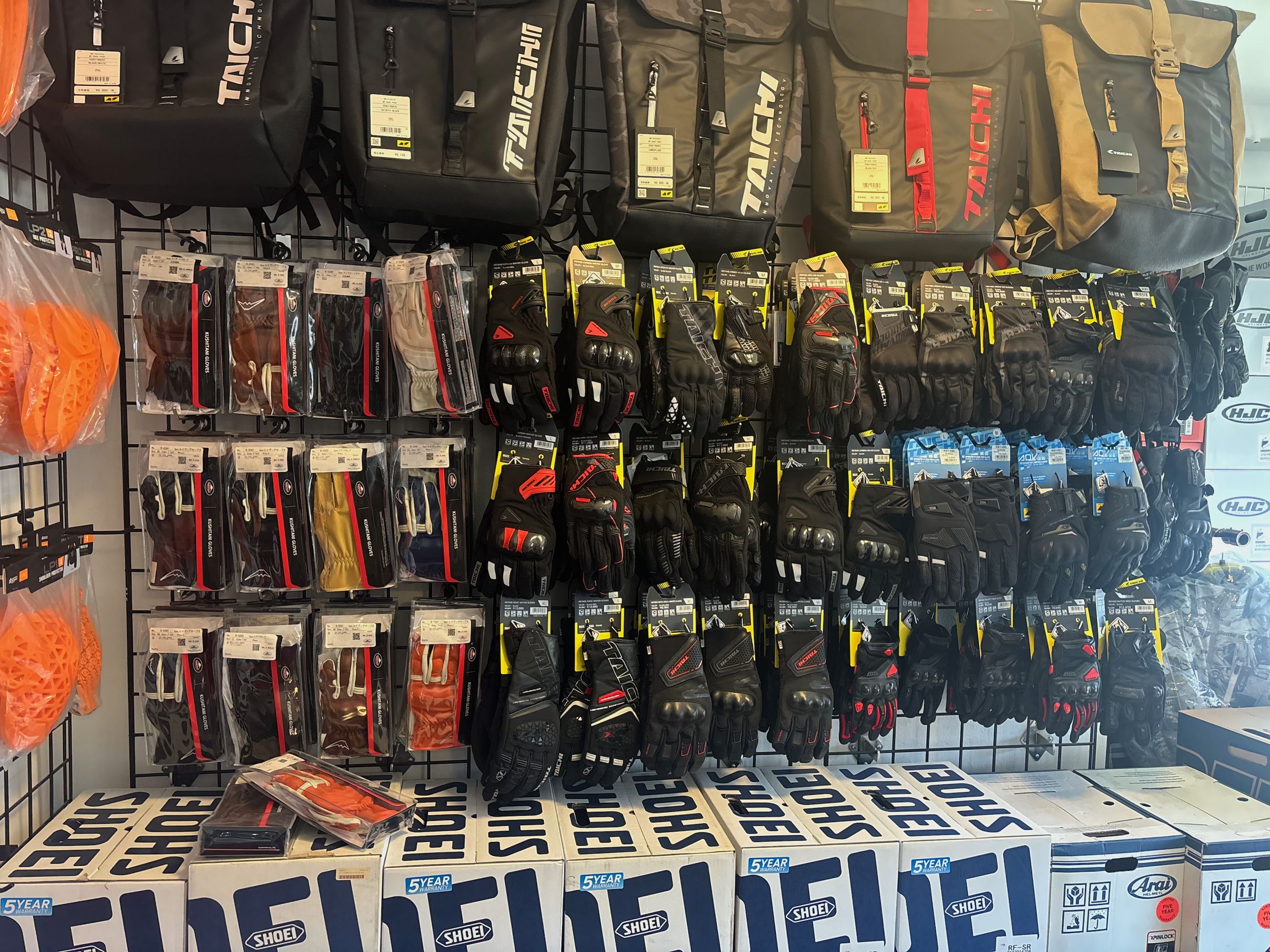 Display of motocross gear including backpacks, gloves, and protective gear in a retail store.