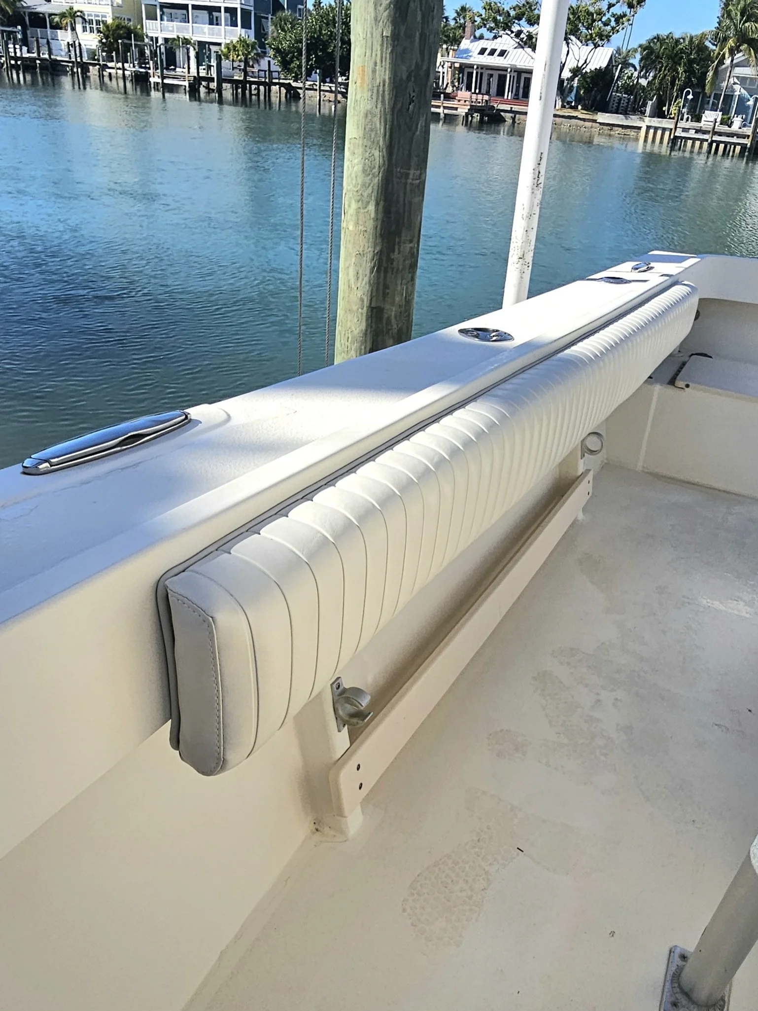 White pleated marine vinyl bolsters on a center console boat. Showcasing marine upholstery