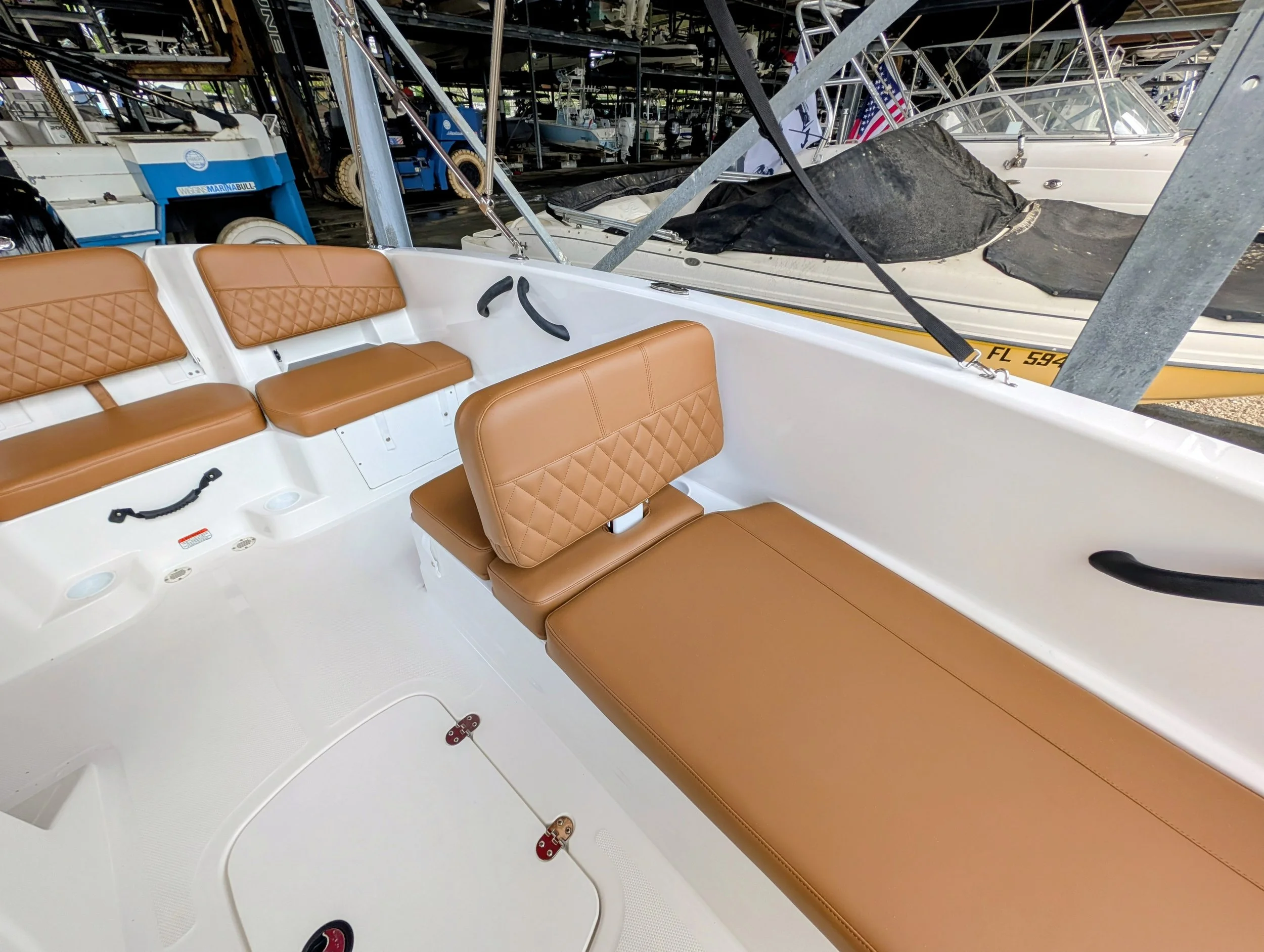 Saddle brown diamond pleated boat cushions. Dual sided back rest and loungers in brown marine vinyl