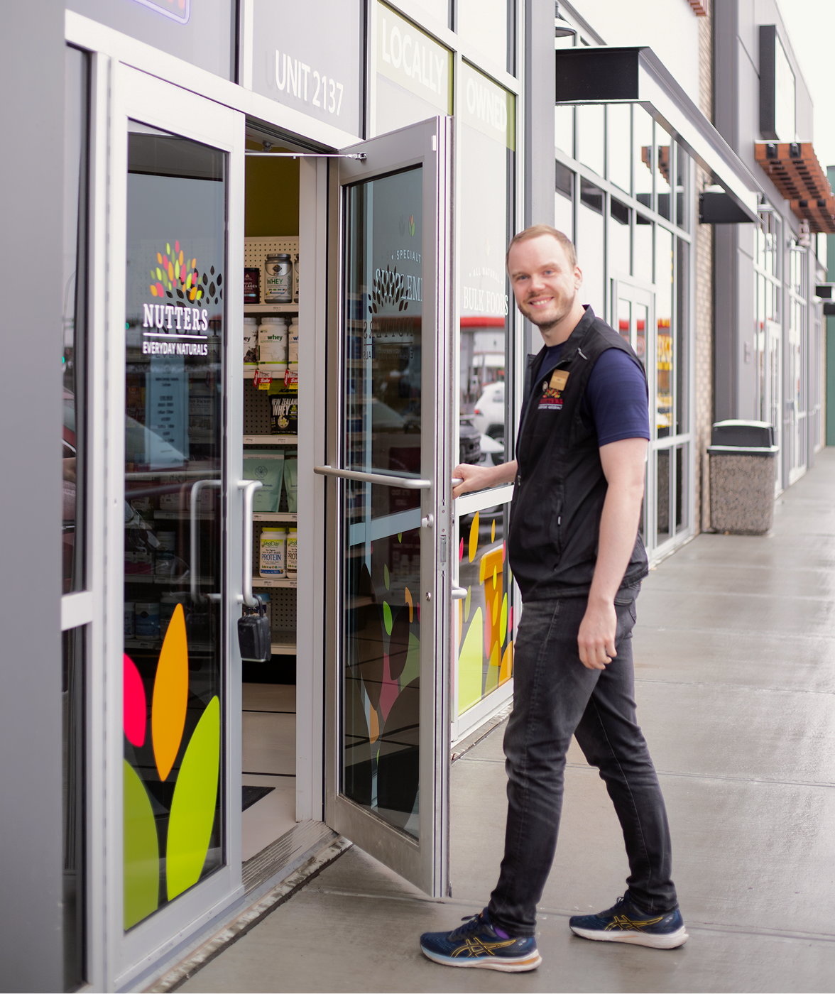 Nutters employee holding open front door of store