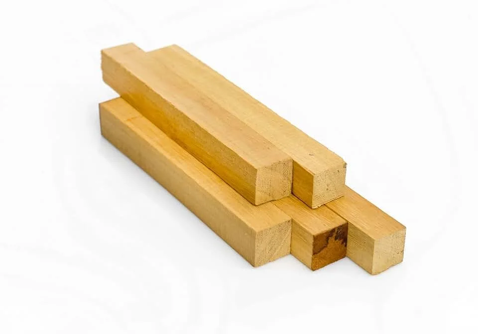Four wooden sticks placed in a cluster on a white background.