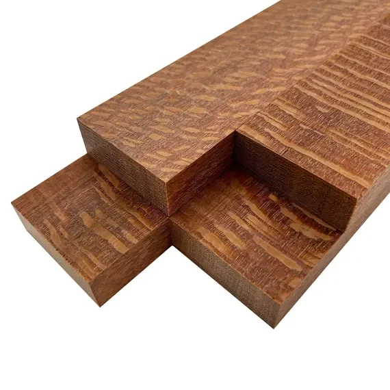 Close-up of a piece of stacked reddish-brown wood with a recessed section.