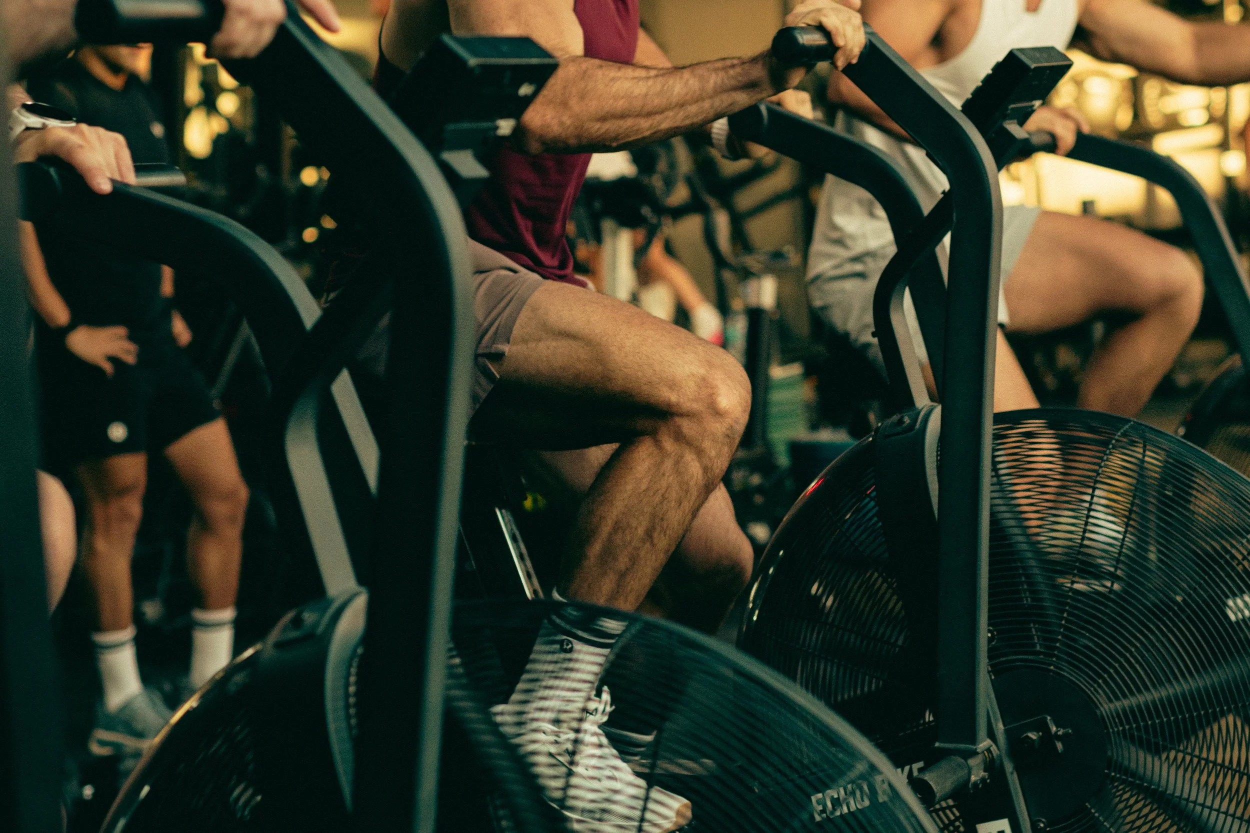People using exercise bikes at a gym.
