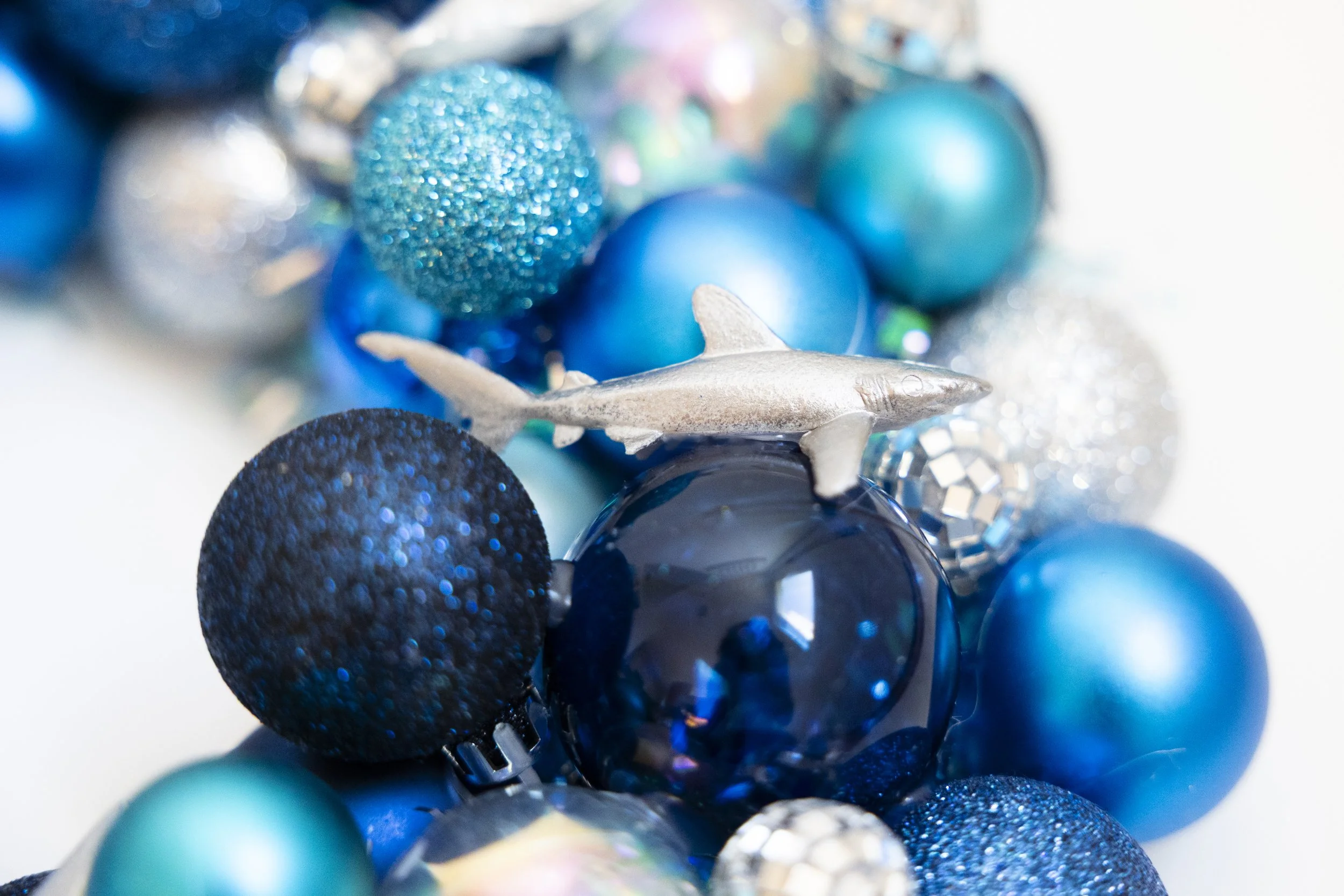 Silver shark on handmade wreath made with blue ornaments and disco balls