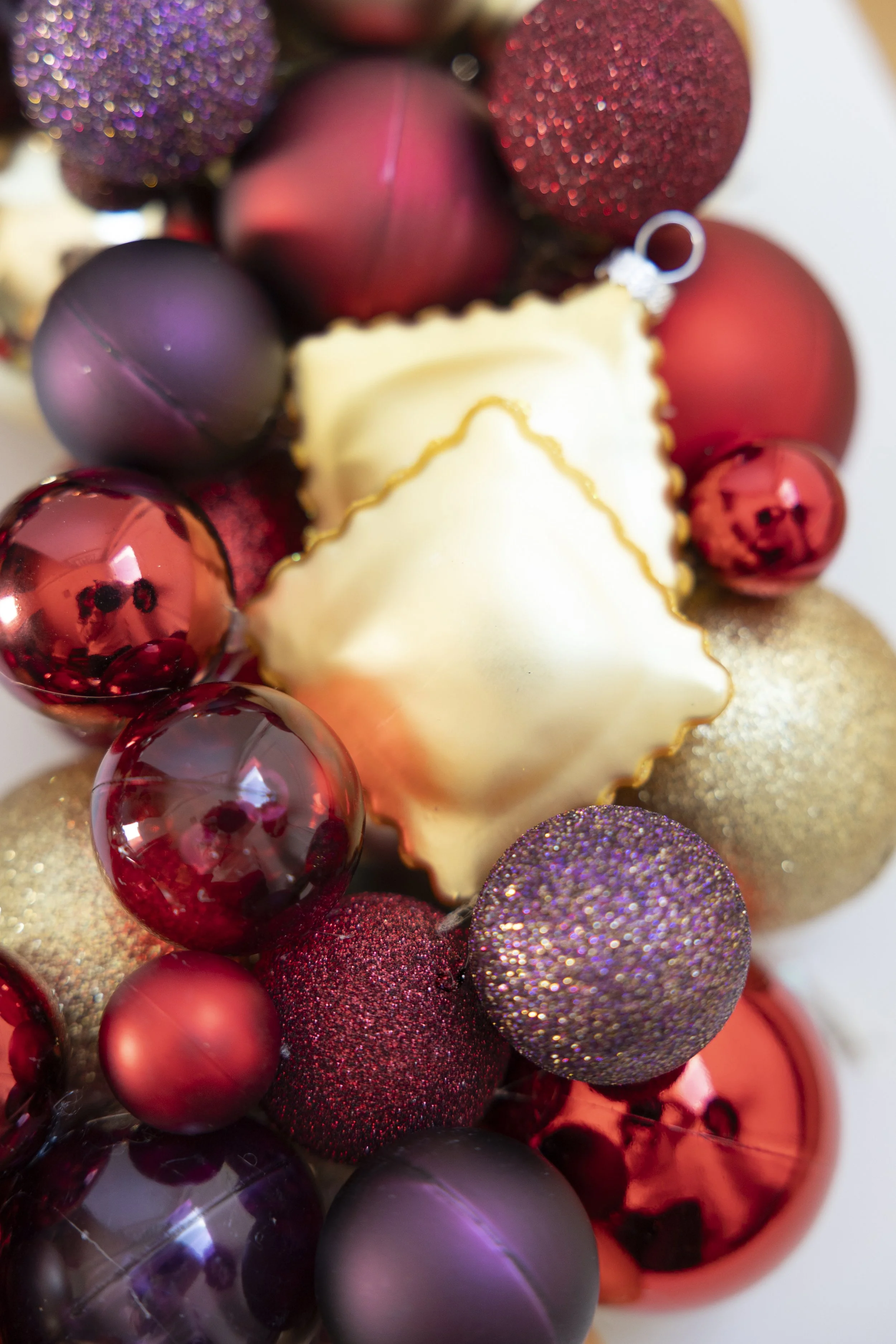 Ravioli ornament on red, gold and purple handmade wreath