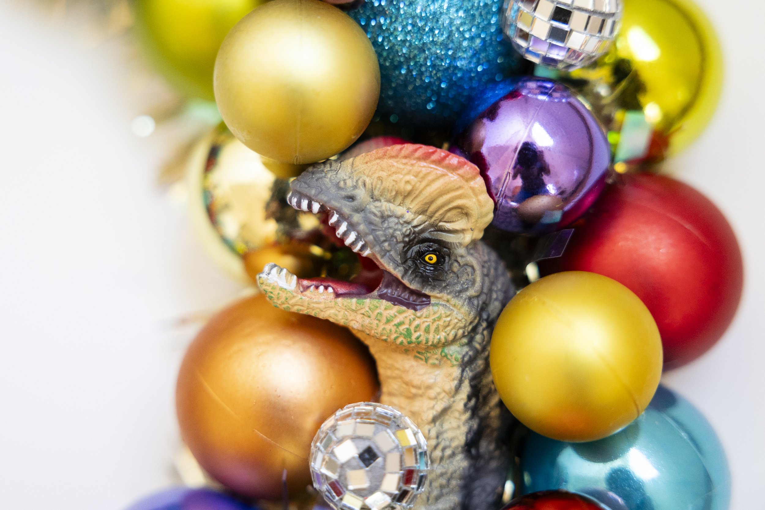 Colorful dinosaur wreath with disco balls and ornaments