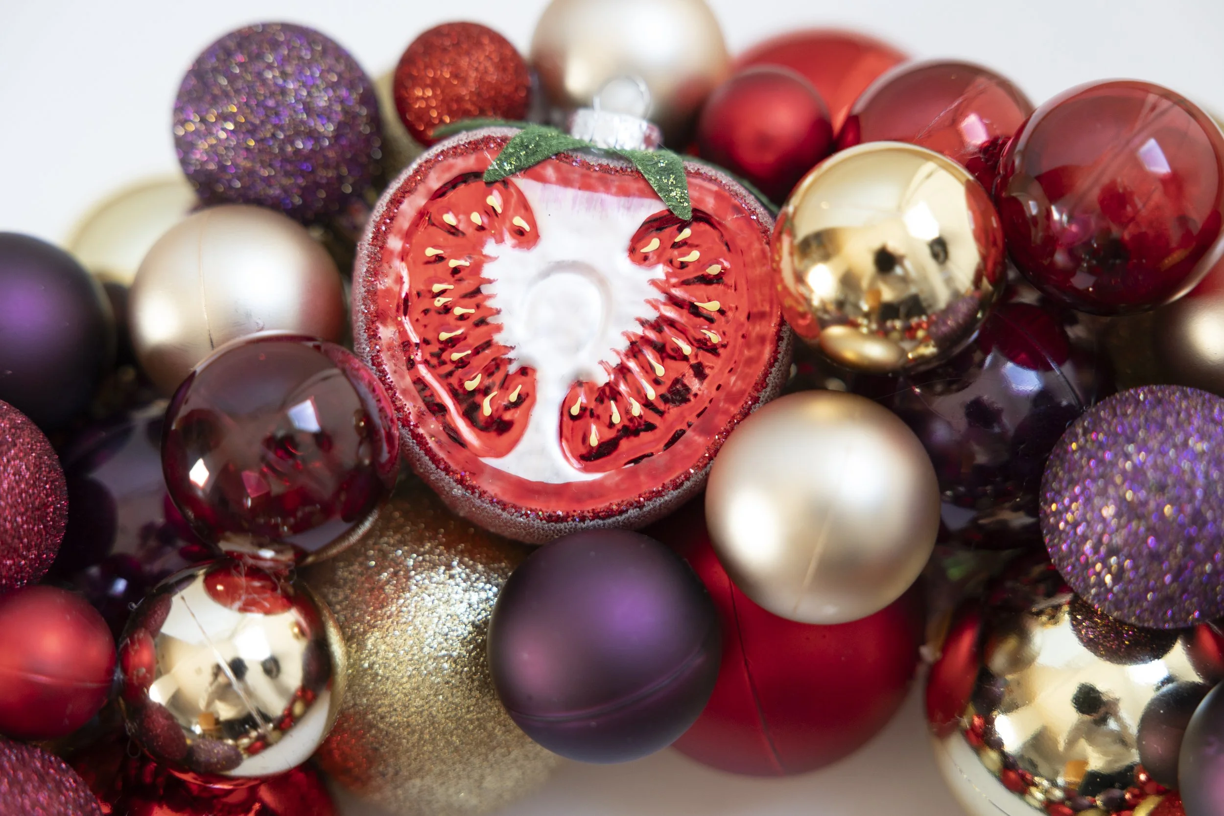 Tomato ornament on red, gold and purple handmade wreath