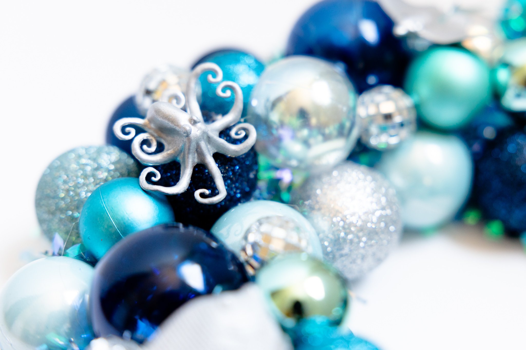 Silver octopus on handmade blue ornament wreath with disco balls