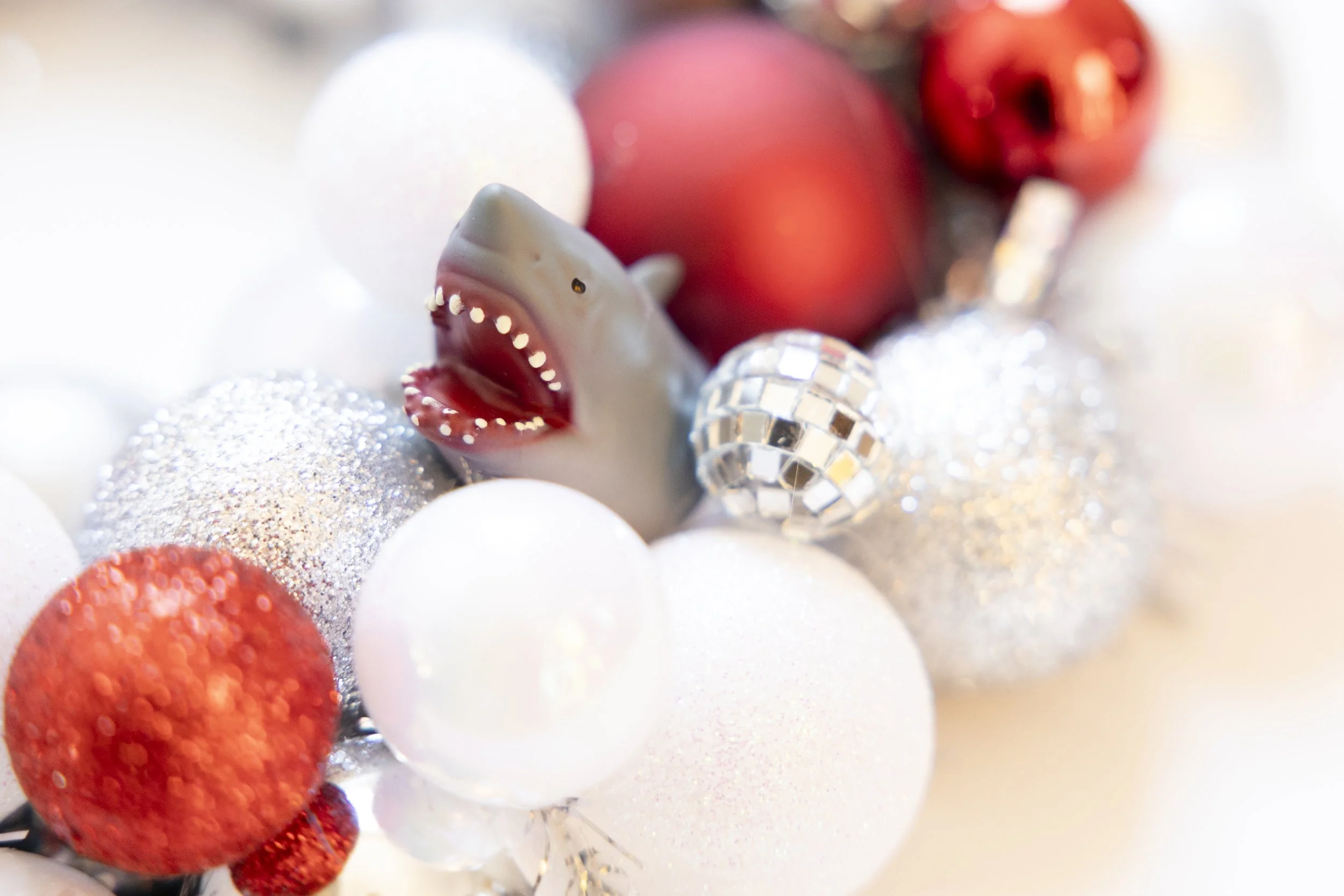 Shiny shark wreath made with red, white and gray ornaments and disco balls