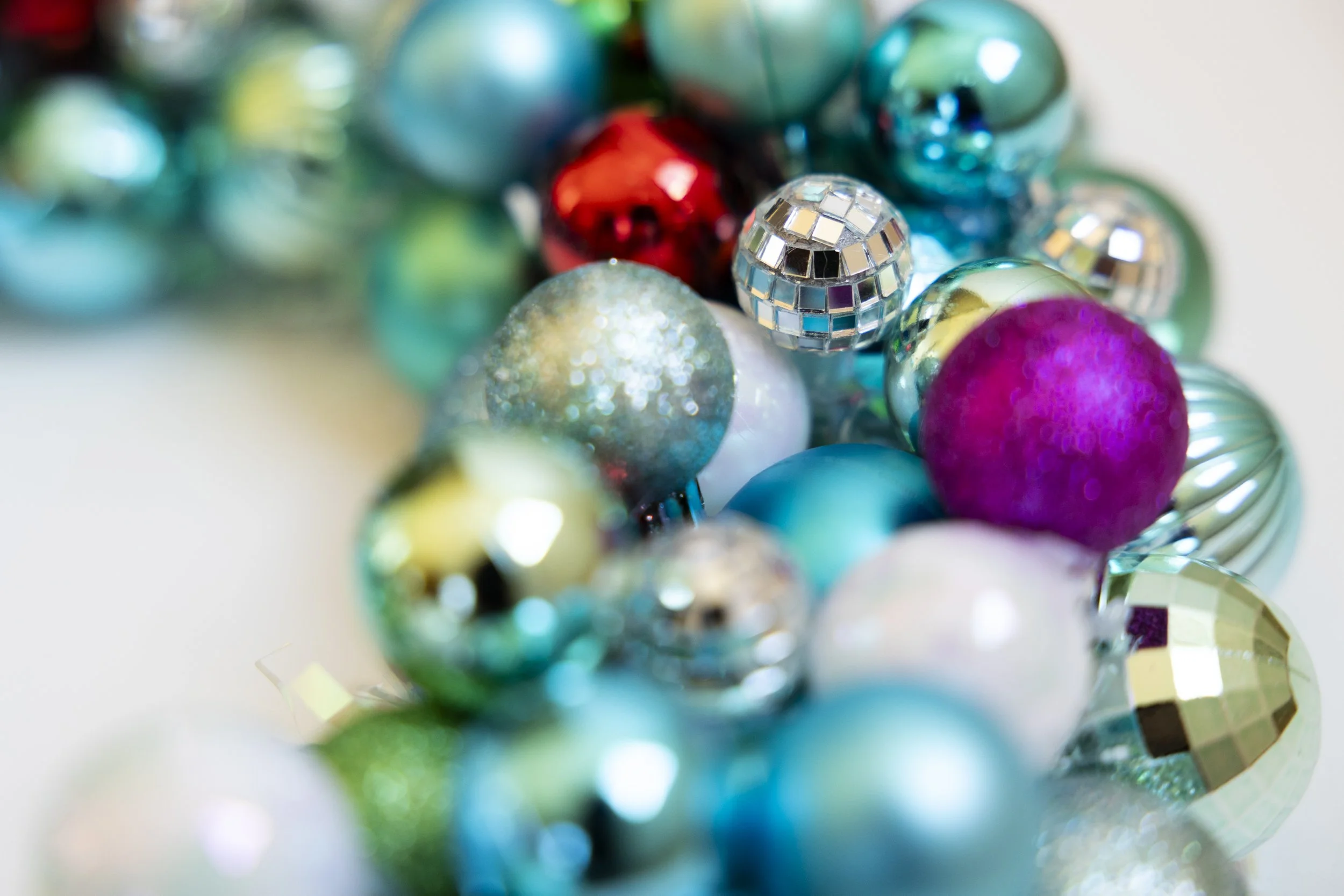 Colorful holiday ornament wreath made with disco balls