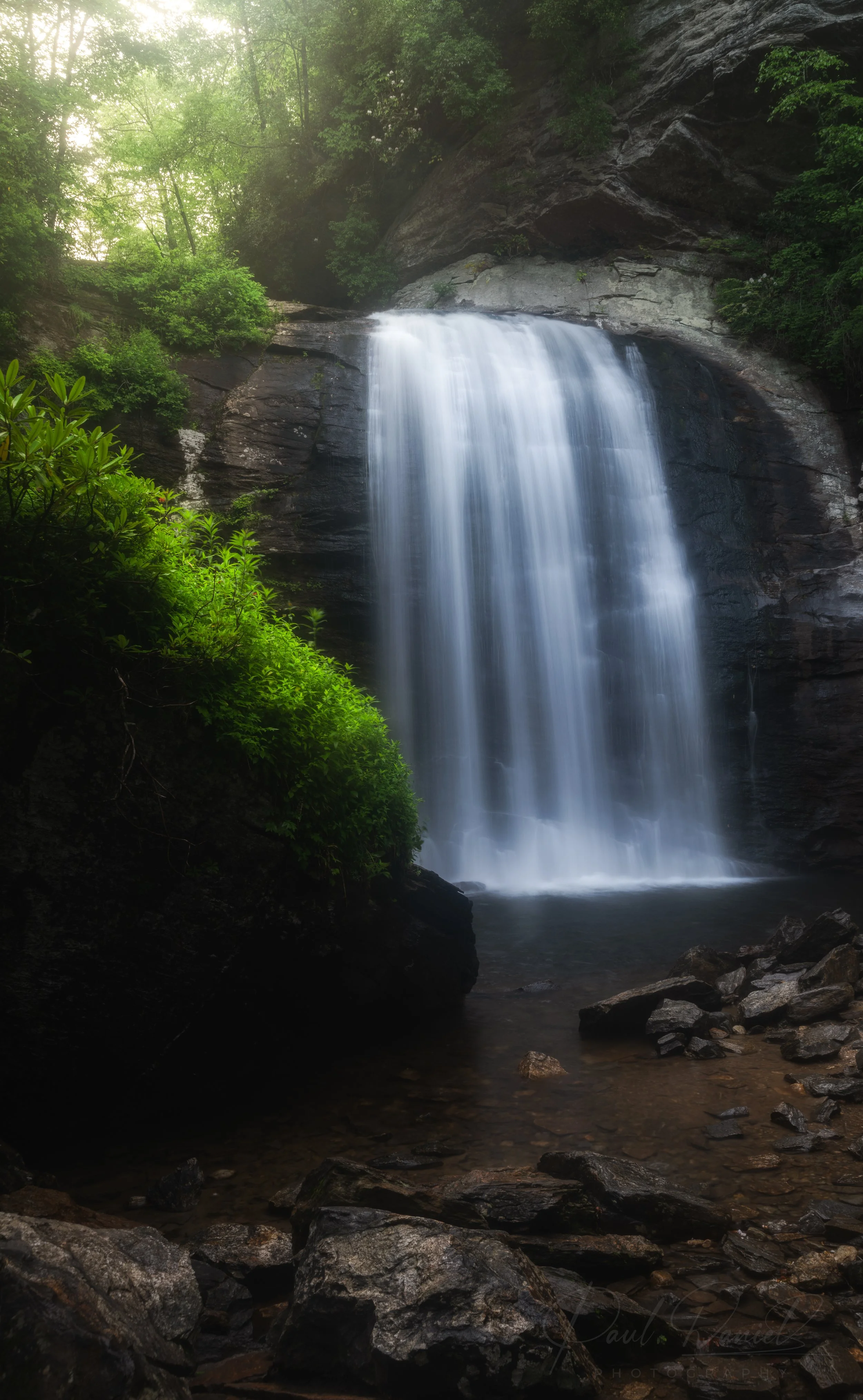 Lone-exposure landscape photography of Looking Glass Falls plunging 60 feet into its rocky pool in Pisgah National Forest off the Blue Ridge Parkway near Brevard, North Carolina 