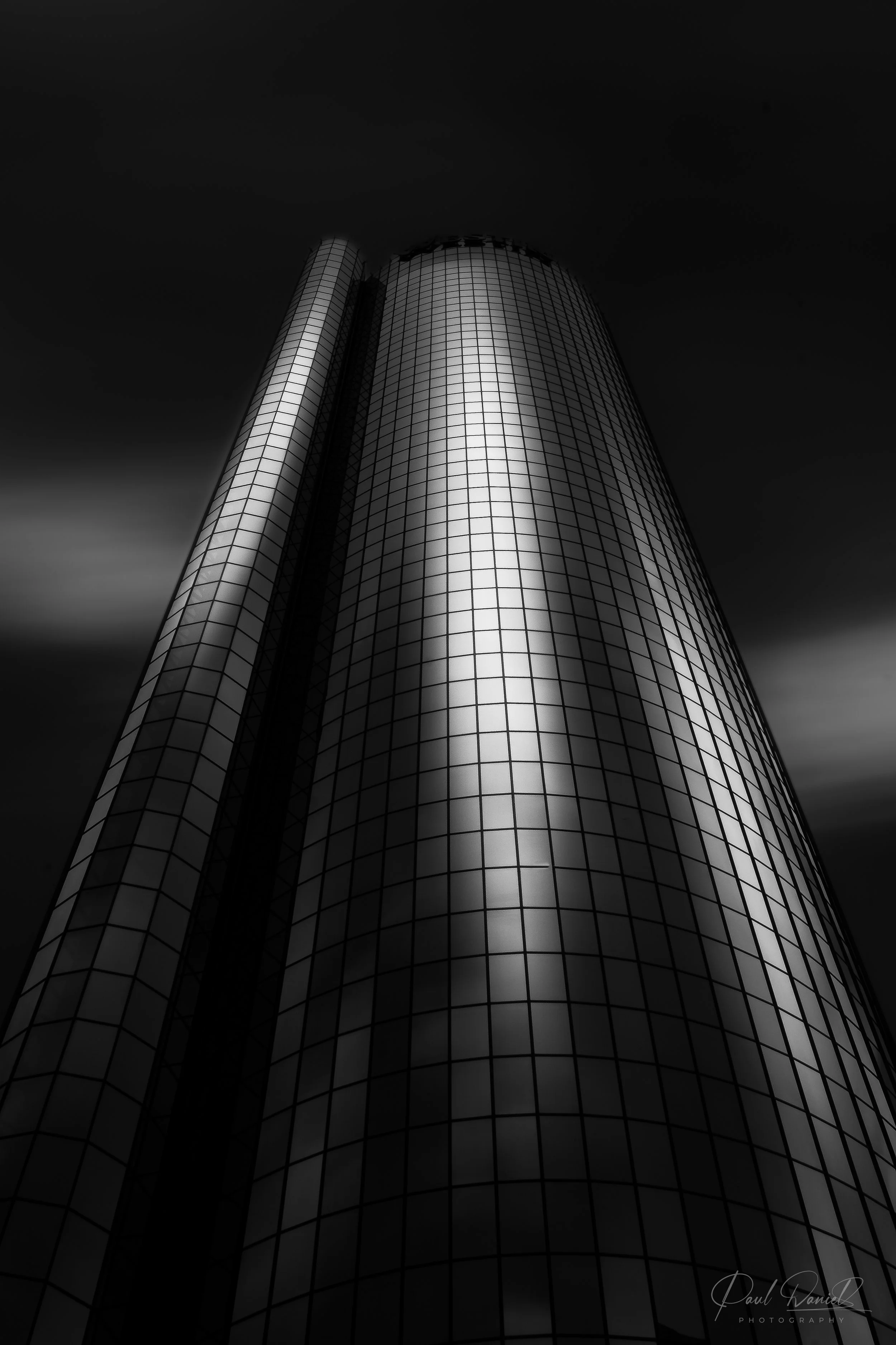 Low-angle architectural view looking up at the cylindrical glass facade of the Westin Peachtree Plaza in Downtown Atlanta